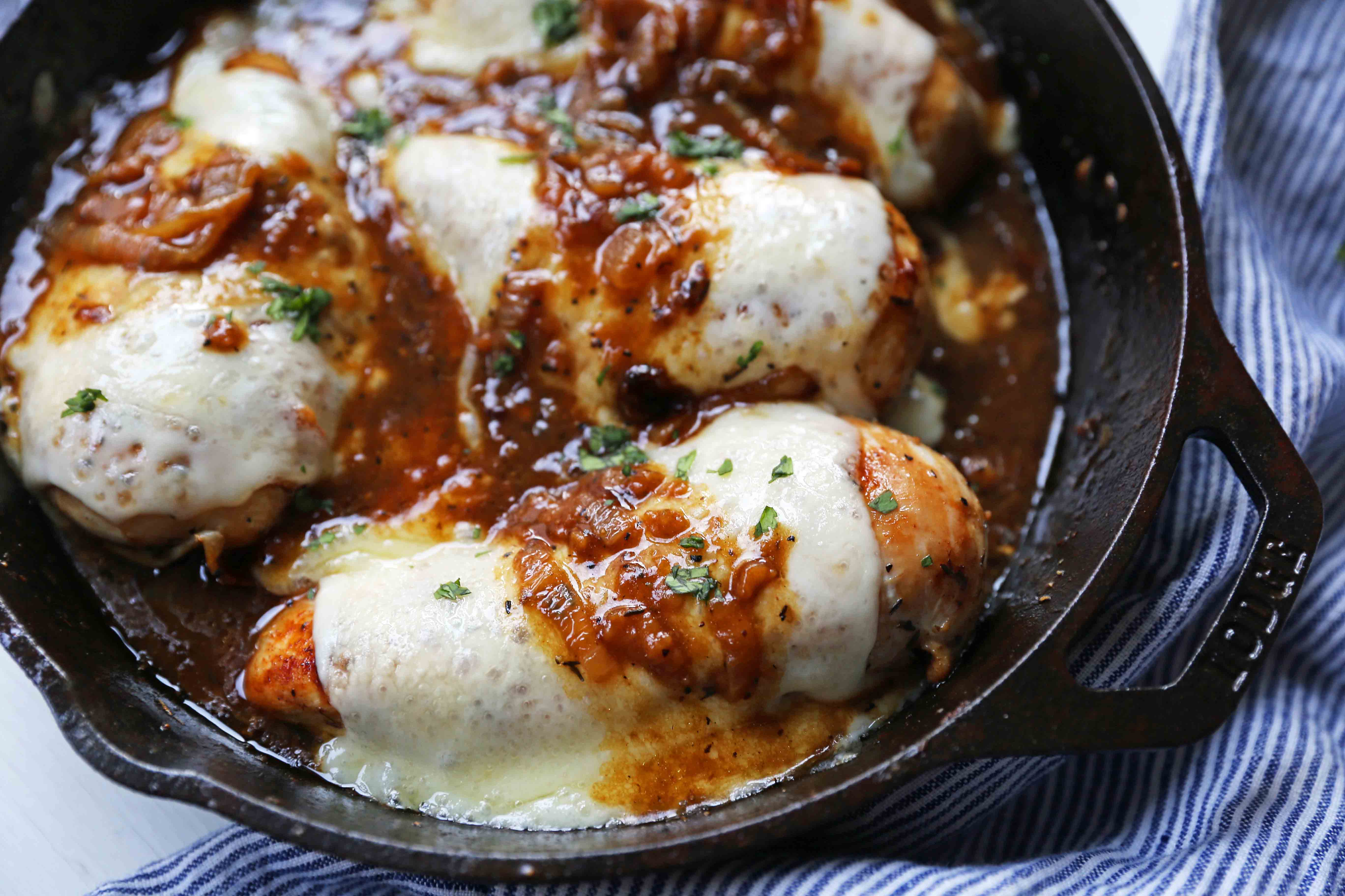 French Onion Chicken Skillet Chicken with Buttery Caramelized Onion Gravy and Melted Cheeses. A simple, flavorful, 30-minute meal! www.modernhoney.com #30minutemeal #dinnerrecipe #frenchonionchicken #cheesychicken #chickendinner