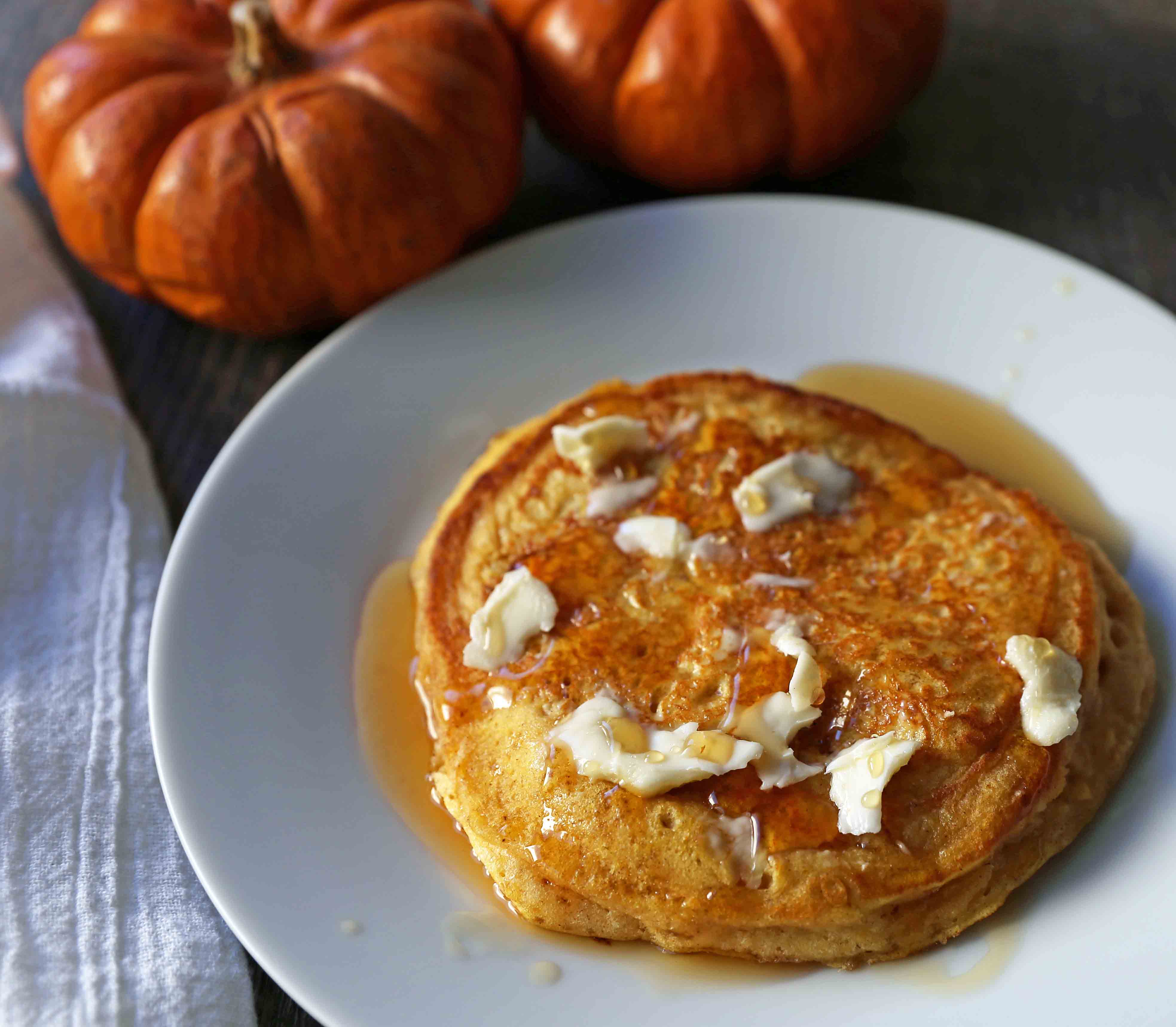 The BEST Pumpkin Pancakes. Light, fluffy, airy, and creamy pumpkin spiced pancakes. The perfect Fall breakfast. www.modernhoney.com #pumpkin #pumpkinpancakes #pumpkinrecipes #pumpkinbreakfast #fallbreakfast #pumpkinspice