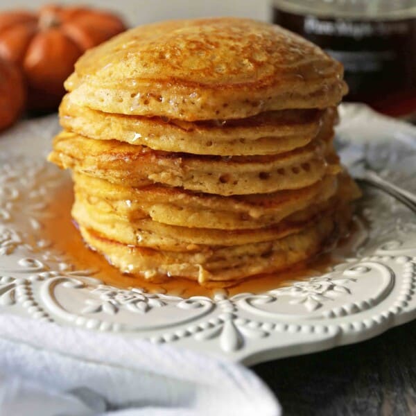 The BEST Pumpkin Pancakes. Light, fluffy, airy, and creamy pumpkin spiced pancakes. The perfect Fall breakfast. www.modernhoney.com #pumpkin #pumpkinpancakes #pumpkinrecipes #pumpkinbreakfast #fallbreakfast #pumpkinspice