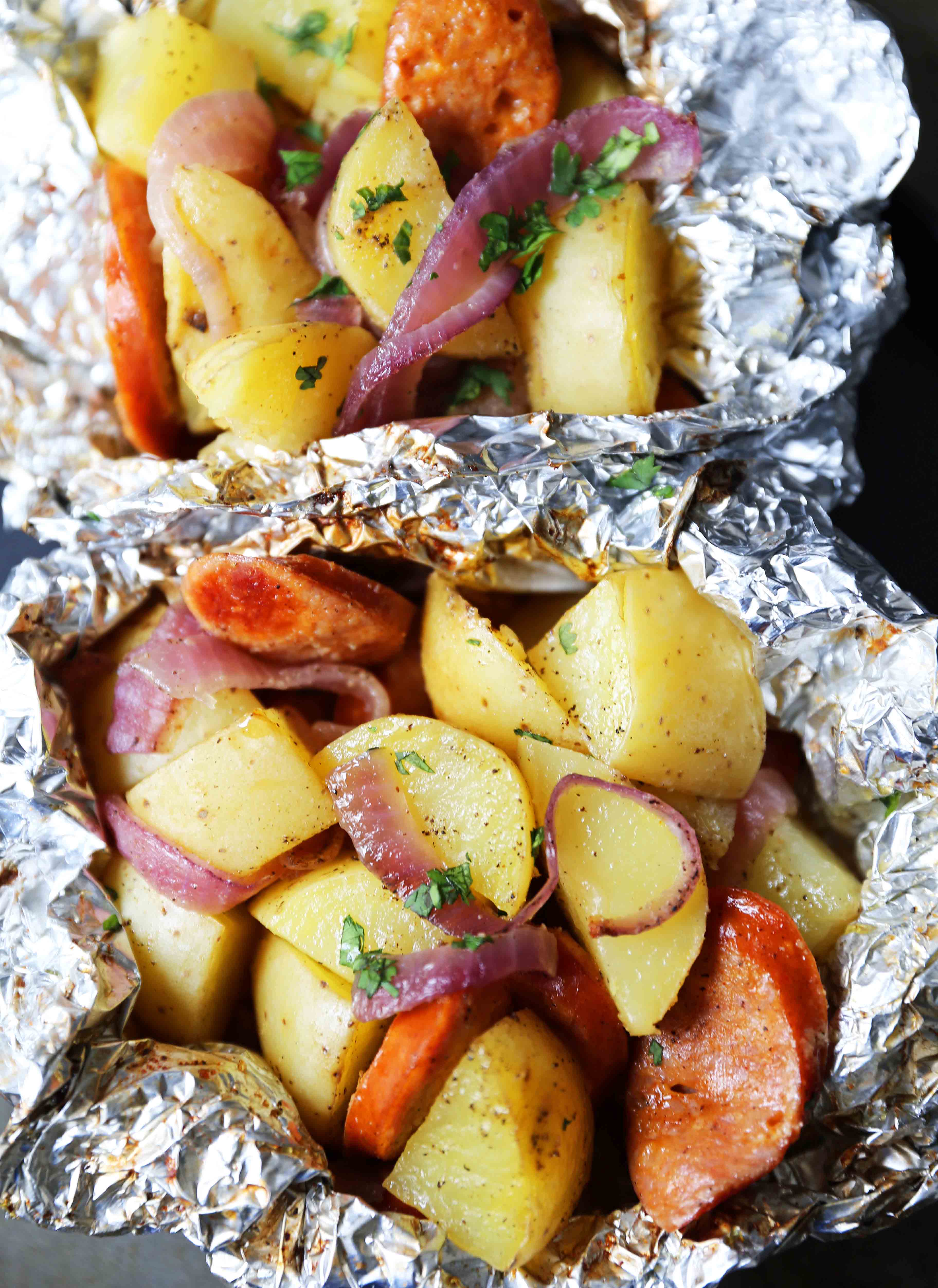 Sausage Potato Foil Packets The modern tin-foil dinner with hardwood smoked sausage and creamy gold potatoes. An easy and flavor-packed dinner. Foil packets cooked in the oven. #tinfoildinners #foilpackets #sausagepotatoes #sausagepotatofoilpackets #ovenfoilpackets