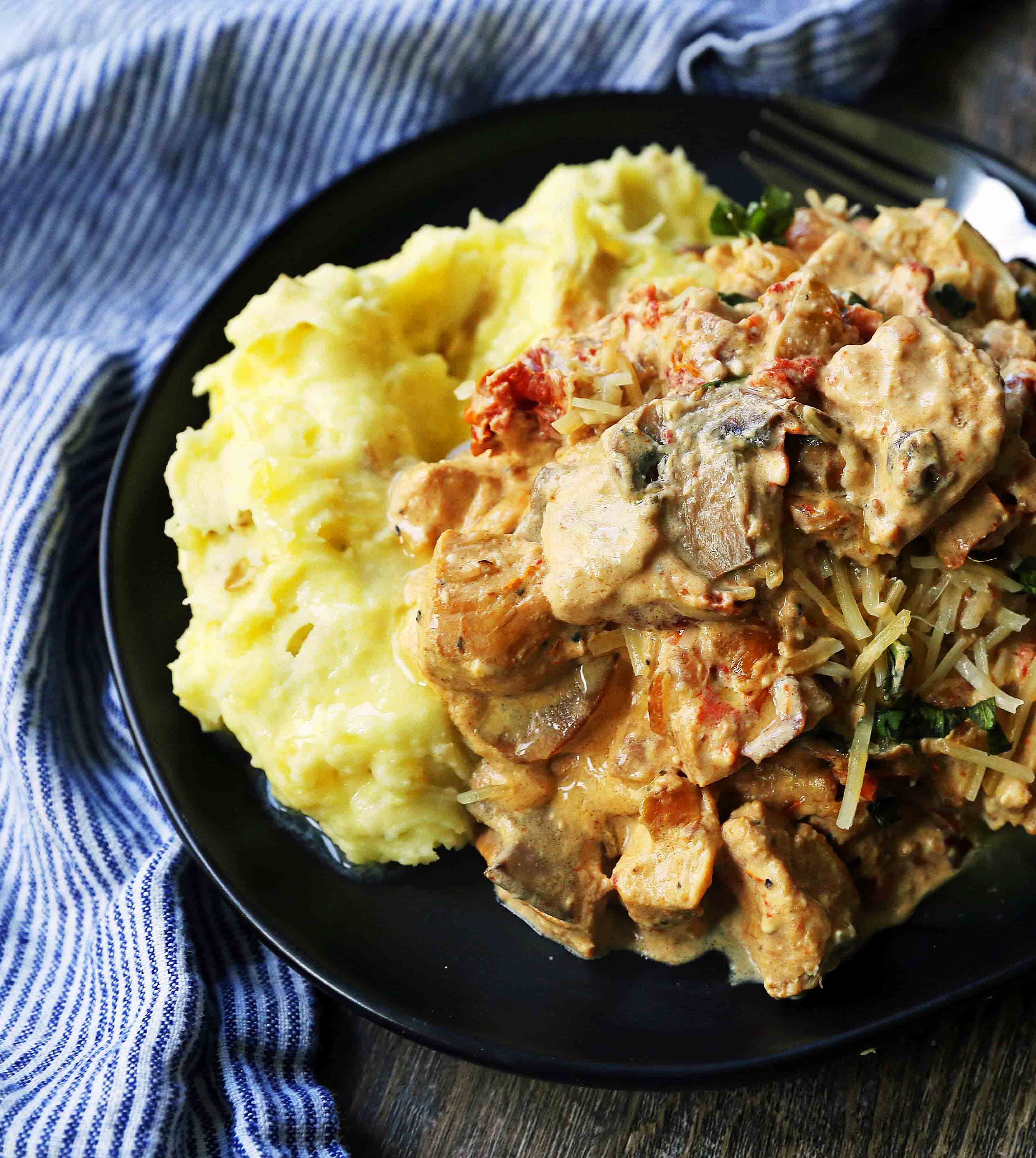 Slow Cooker Creamy Tuscan Chicken. Creamy tender chicken in prosciutto, mushroom, and sundried tomato cream sauce. Comfort food made in a slow cooker. www.modernhoney.com #dinner #slowcooker #slowcookerchicken #chickendinnerrecipes #creamychicken