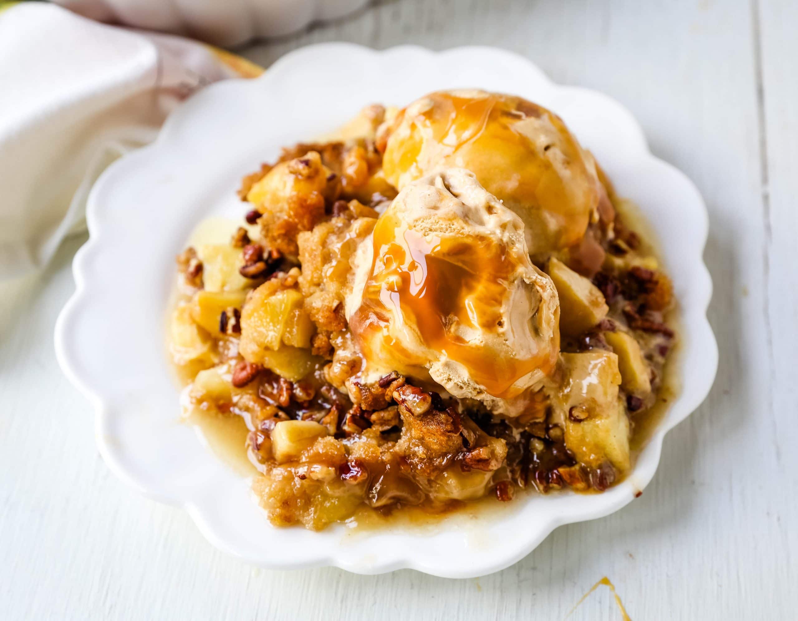 Apple Crisp. A classic Fall dessert made with sweet and tart apples and a homemade buttery brown sugar topping. This Apple Crisp recipe is made with freshly chopped sweetened apples with a handcrafted brown sugar crumble. It is a warm comforting dessert topped with vanilla bean ice cream and salted caramel. www.modernhoney.com #applecrisp #appledesserts #appledessert #dessert
