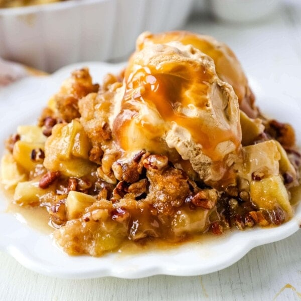 Apple Crisp. A classic Fall dessert made with sweet and tart apples and a homemade buttery brown sugar topping. This Apple Crisp recipe is made with freshly chopped sweetened apples with a handcrafted brown sugar crumble. It is a warm comforting dessert topped with vanilla bean ice cream and salted caramel. www.modernhoney.com #applecrisp #appledesserts #appledessert #dessert