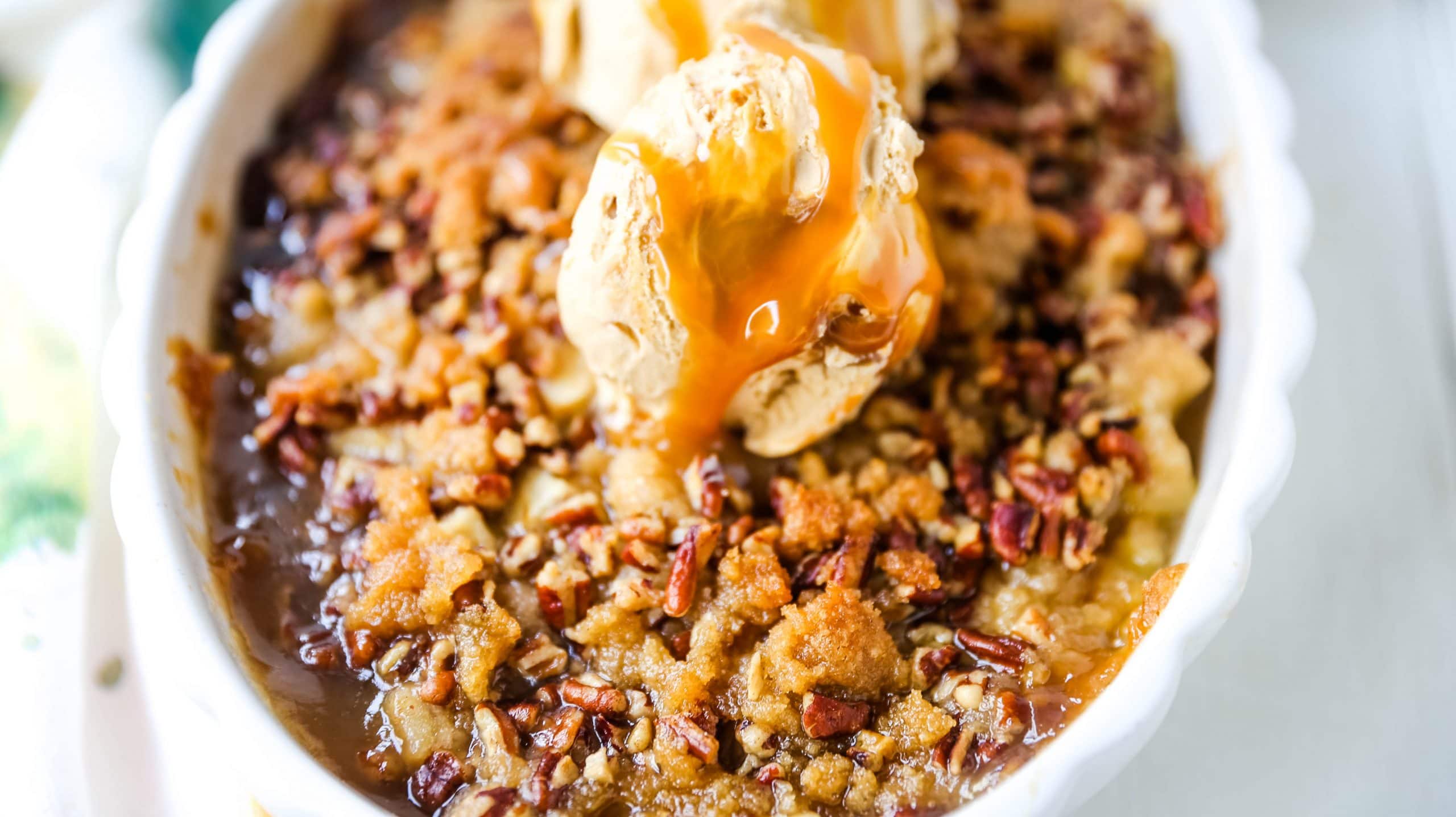 Apple Crisp. A classic Fall dessert made with sweet and tart apples and a homemade buttery brown sugar topping. This Apple Crisp recipe is made with freshly chopped sweetened apples with a handcrafted brown sugar crumble. It is a warm comforting dessert topped with vanilla bean ice cream and salted caramel. www.modernhoney.com #applecrisp #appledesserts #appledessert #dessert