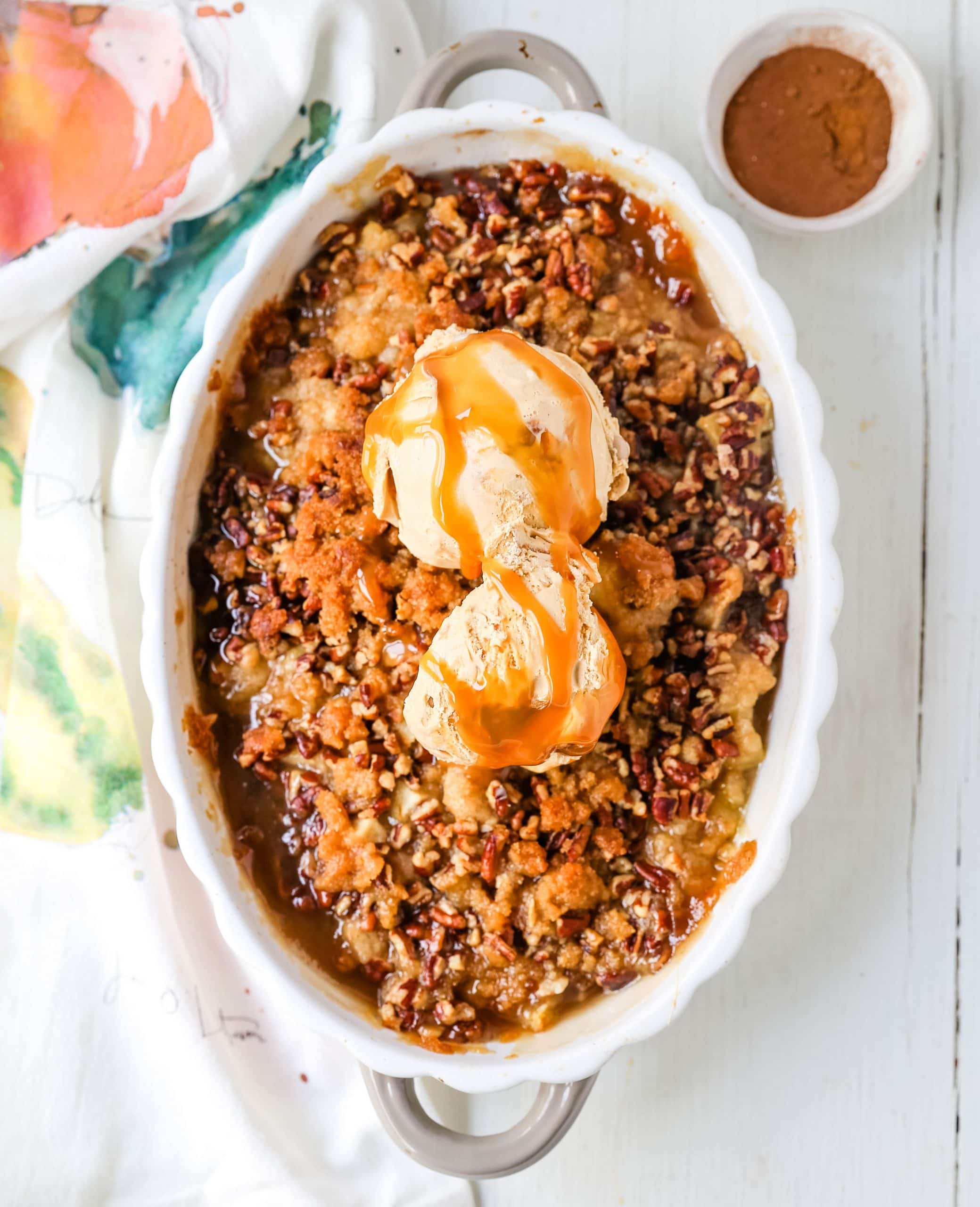 Apple Crisp. A classic Fall dessert made with sweet and tart apples and a homemade buttery brown sugar topping. This Apple Crisp recipe is made with freshly chopped sweetened apples with a handcrafted brown sugar crumble. It is a warm comforting dessert topped with vanilla bean ice cream and salted caramel. www.modernhoney.com #applecrisp #appledesserts #appledessert #dessert