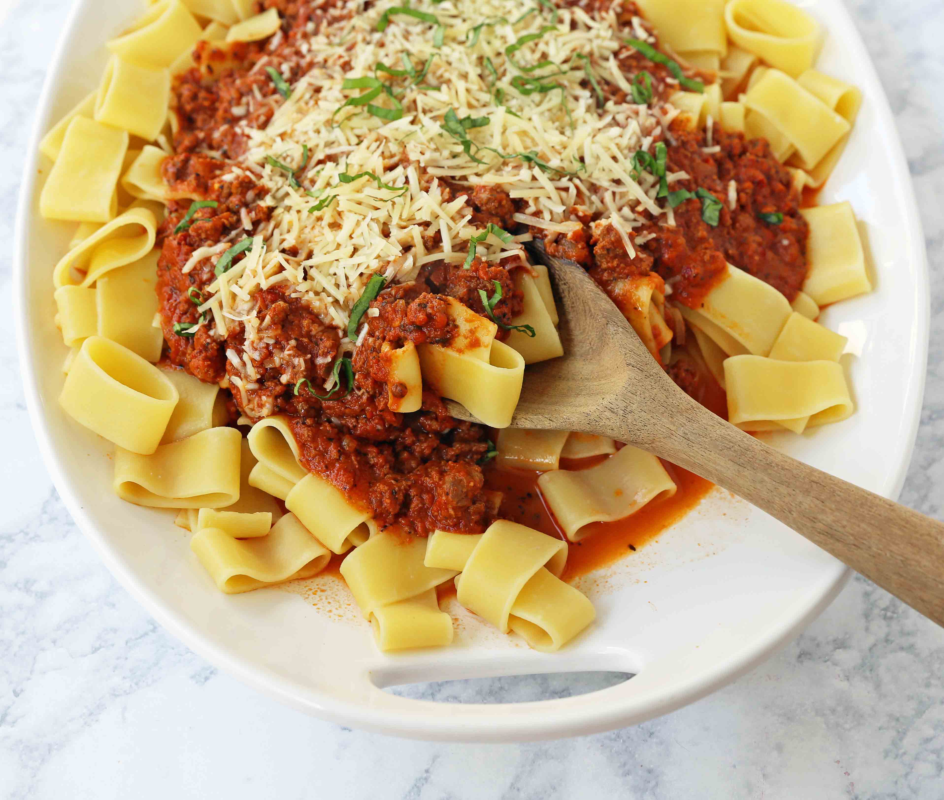 Beef Bolognese Sauce. Authentic Italian Beef Bolognese Sauce on top of fresh pasta is a warm, weeknight dish made in less than 30 minutes. www.modernhoney.com #italian #beefbolognese #pasta #spaghetti #italianfood