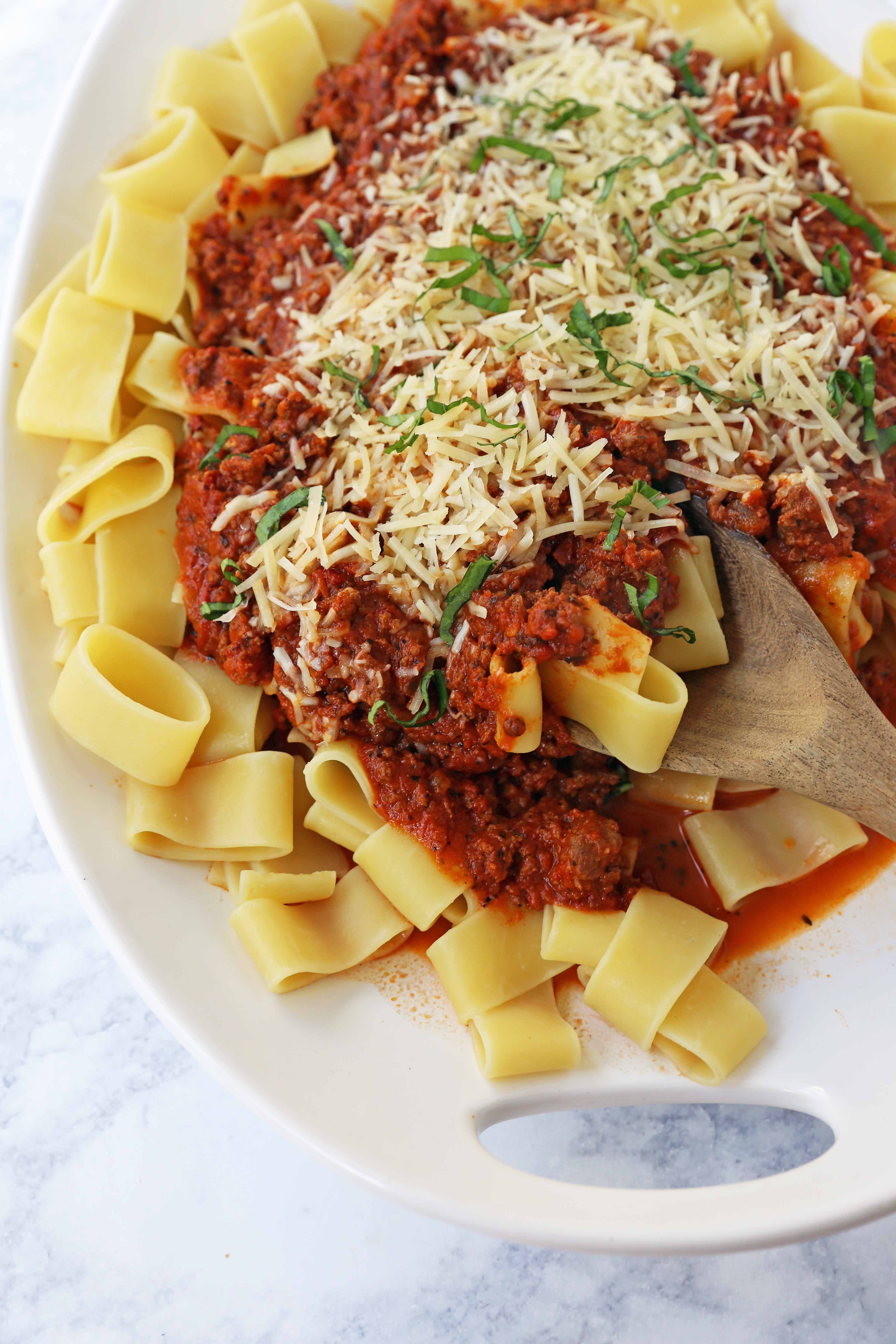 Beef Bolognese Sauce. Authentic Italian Beef Bolognese Sauce on top of fresh pasta is a warm, weeknight dish made in less than 30 minutes. www.modernhoney.com #italian #beefbolognese #pasta #spaghetti #italianfood