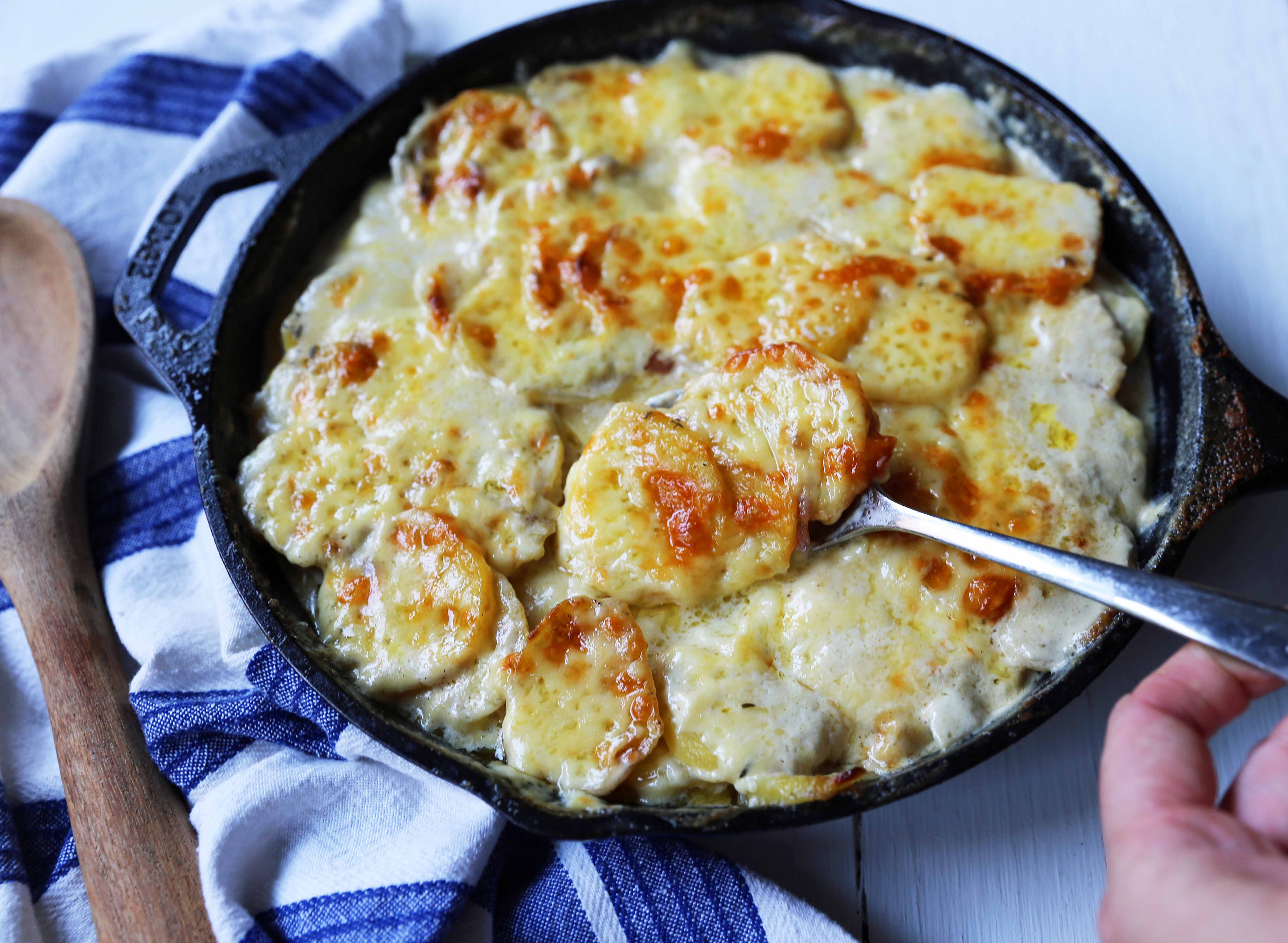 Cheesy Potatoes Au Gratin. Homemade cheesy scalloped potatoes with a rich cream sauce and melted cheddar cheese. The perfect potato side dish recipe! www.modernhoney.com #scallopedpotatoes #potatoesaugratin #potatoes #potato #thanksgiving