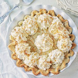 Coconut Cream Pie. A homemade coconut custard filling in a buttery pie crust topped with fresh whipped cream and toasted coconut. www.modernhoney.com #coconutcreampie #coconutpie #pie