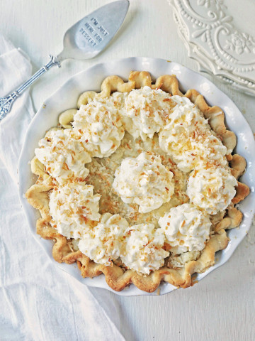 Coconut Cream Pie. A homemade coconut custard filling in a buttery pie crust topped with fresh whipped cream and toasted coconut. www.modernhoney.com #coconutcreampie #coconutpie #pie