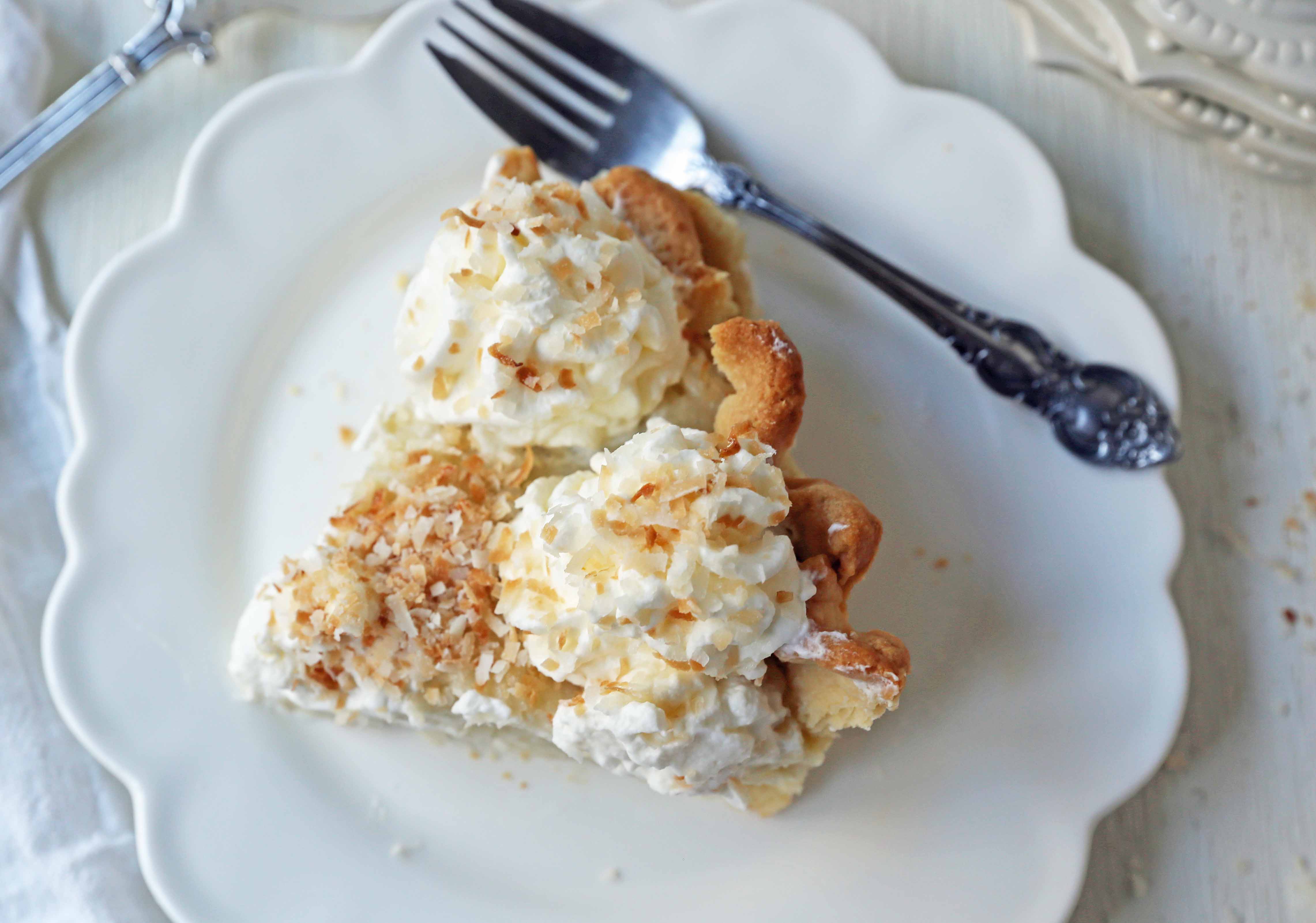 Coconut Cream Pie. A homemade coconut custard filling in a buttery pie crust topped with fresh whipped cream and toasted coconut. www.modernhoney.com #coconutcreampie #coconutpie #pie 