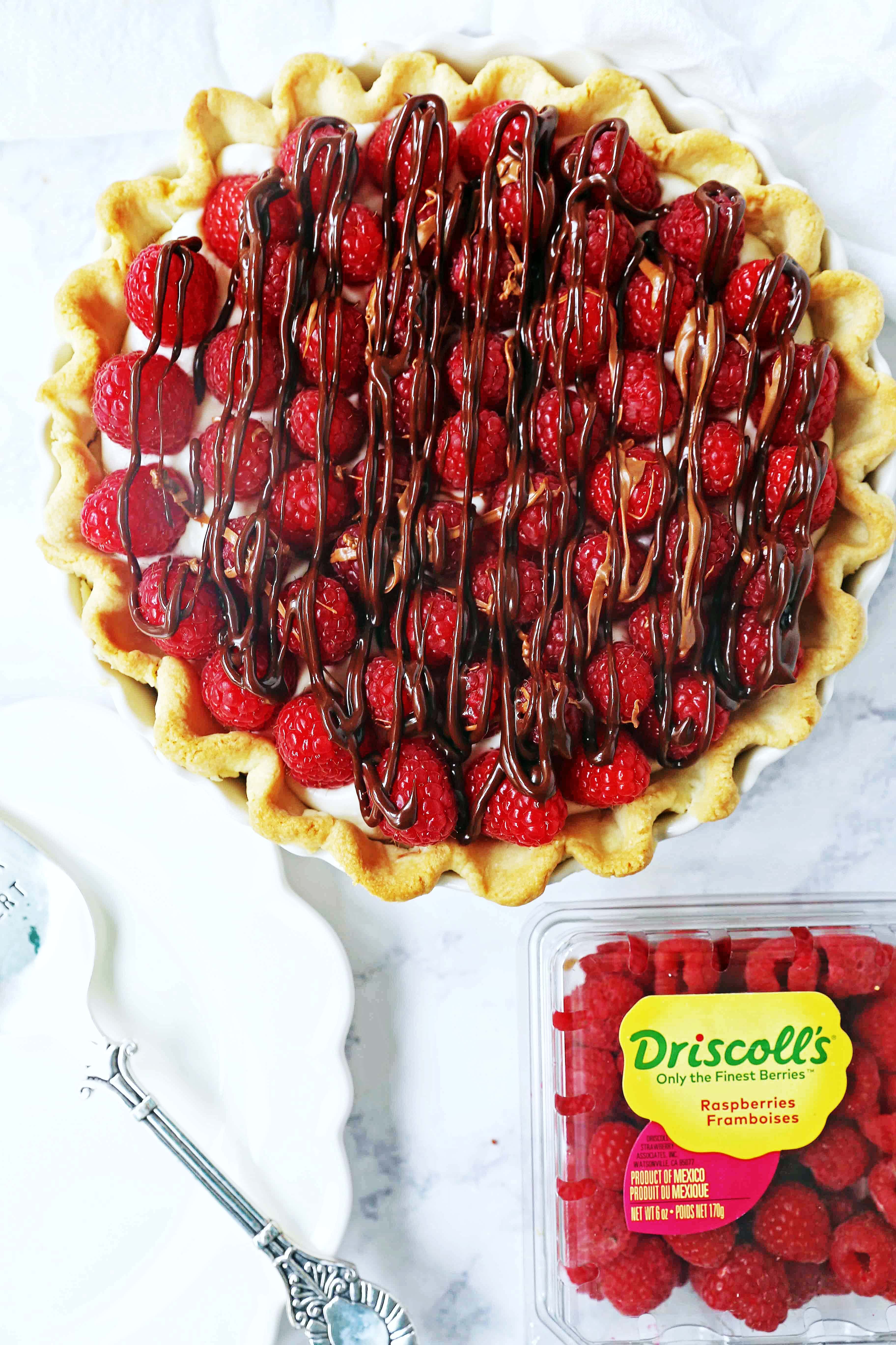 Raspberry Almond Cream Cheese Pie. A simple cream cheese almond pie with fresh raspberries and chocolate drizzle. An award-winning easy pie recipe! www.modernhoney.com #creamcheesepie #raspberrypie #pie #pierecipe #driscolls