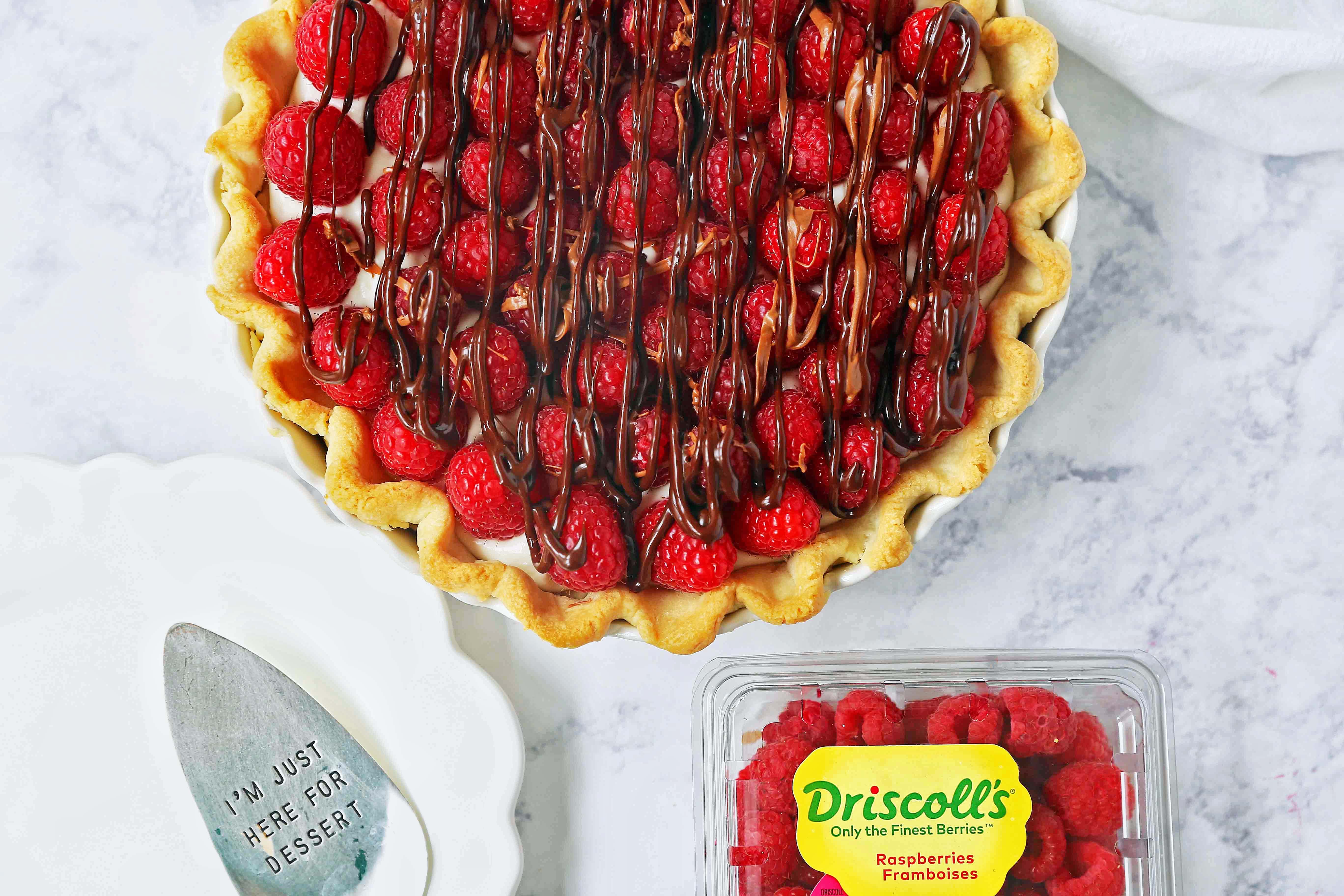 Raspberry Almond Cream Cheese Pie. A simple cream cheese almond pie with fresh raspberries and chocolate drizzle. An award-winning easy pie recipe! www.modernhoney.com #creamcheesepie #raspberrypie #pie #pierecipe #driscolls