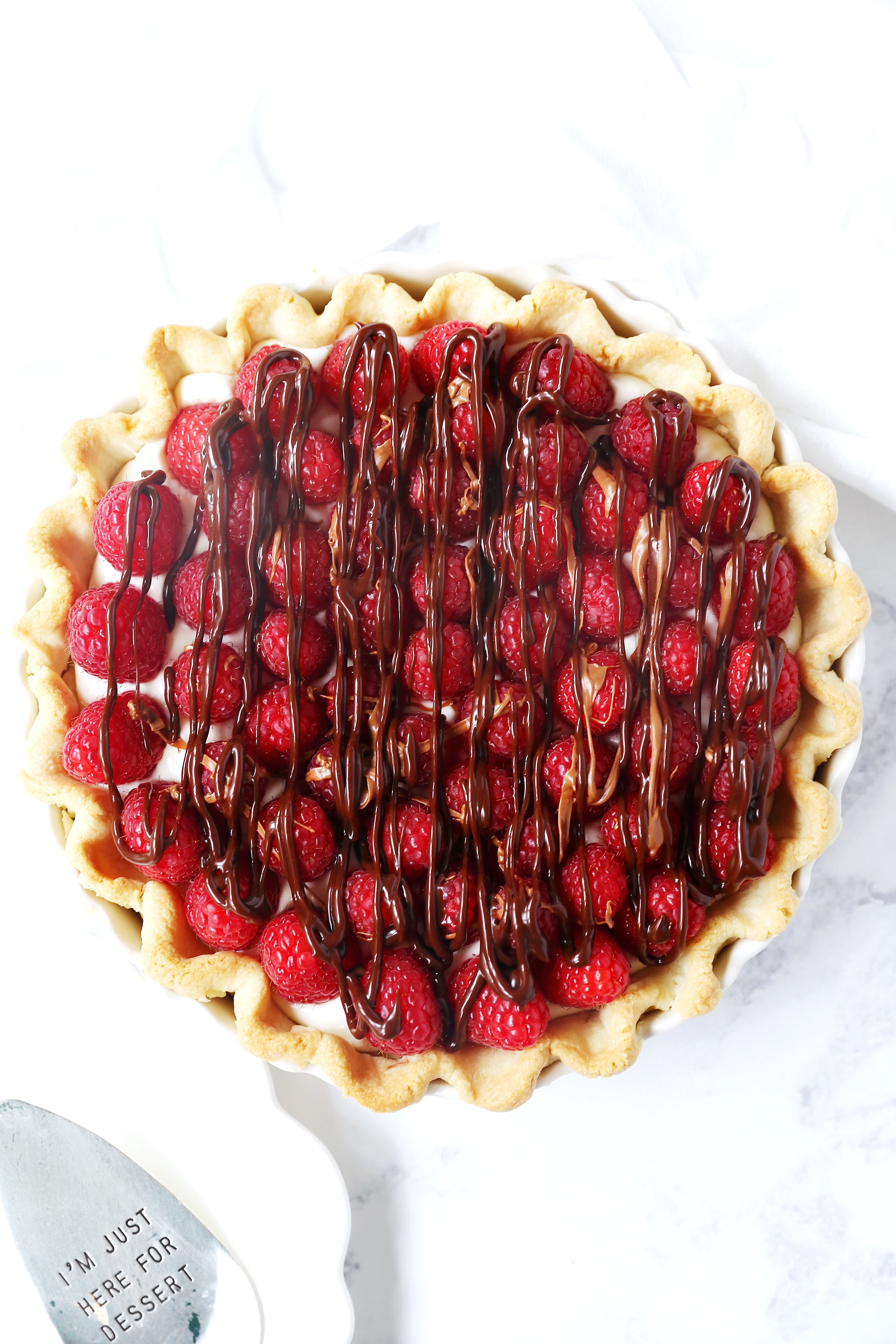 Raspberry Almond Cream Cheese Pie. A simple cream cheese almond pie with fresh raspberries and chocolate drizzle. An award-winning easy pie recipe! www.modernhoney.com #creamcheesepie #raspberrypie #pie #pierecipe #driscolls