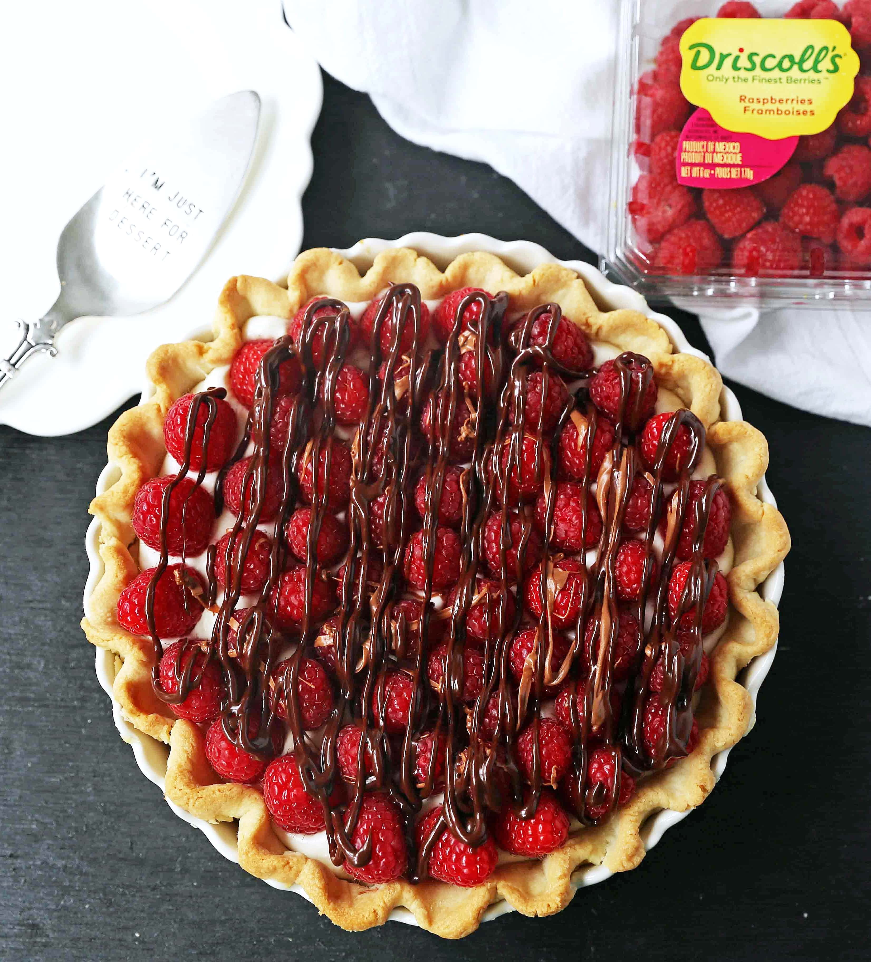 Raspberry Almond Cream Cheese Pie. A simple cream cheese almond pie with fresh raspberries and chocolate drizzle. An award-winning easy pie recipe! www.modernhoney.com #creamcheesepie #raspberrypie #pie #pierecipe #driscolls