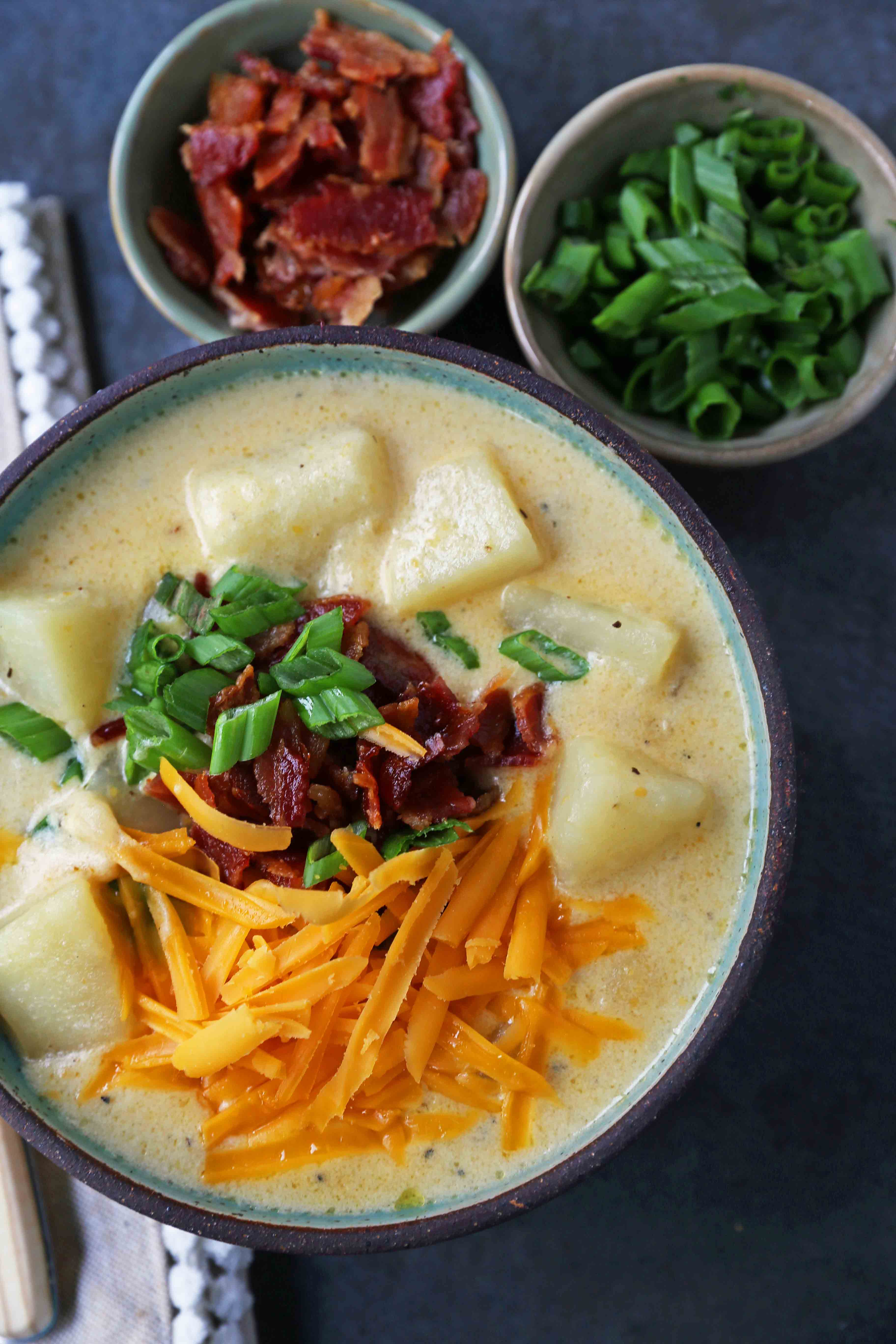 Loaded Baked Potato Soup. Creamy Cheesy Potato Soup topped with crispy bacon, green onions, sharp cheddar cheese, and sour cream. The perfect baked potato soup recipe. www.modernhoney.com #soup #soups #bakedpotatosoup #potatosoup #creamsoup www.modernhoney.com