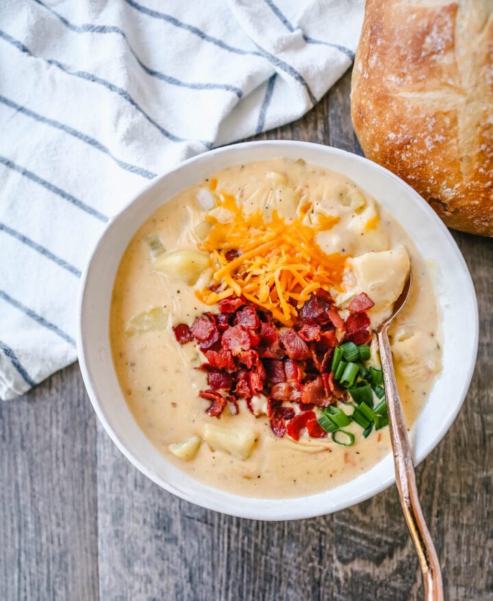 Loaded Baked Potato Soup is a rich and creamy potato cheese soup topped with crispy bacon, sour cream, green onions, and sharp cheddar cheese. A family favorite potato cheese soup recipe!
