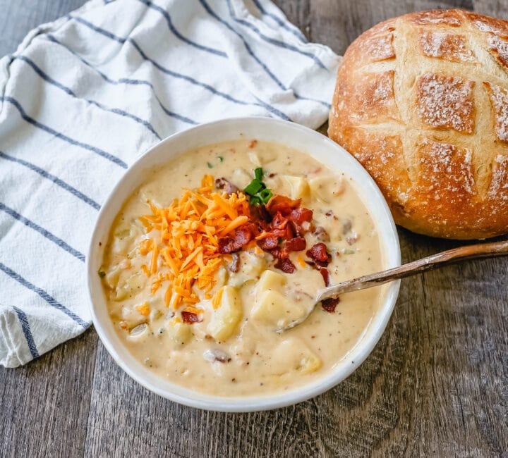 Loaded Baked Potato Soup is a rich and creamy potato cheese soup topped with crispy bacon, sour cream, green onions, and sharp cheddar cheese. A family favorite potato cheese soup recipe!