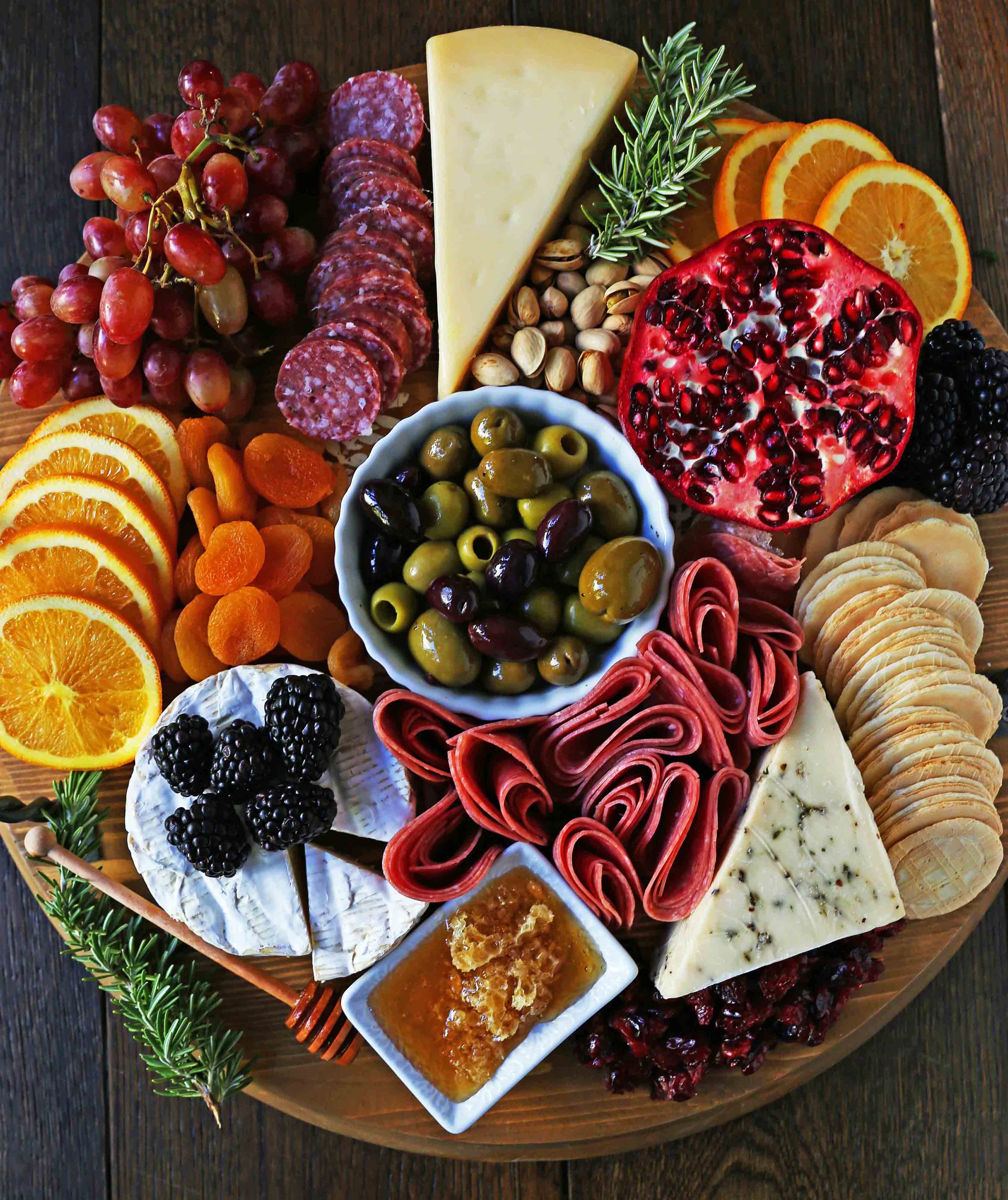 How to make an EPIC Charcuterie Board (AKA Meat and Cheese Platter). How to make a beautiful meat cheese and fruit platter. The perfect appetizer for your next party! www.modernhoney.com #meatboard #meatandcheeseboard #appetizer #appetizers #charcuterieboard #charcuterie #cheeseboard