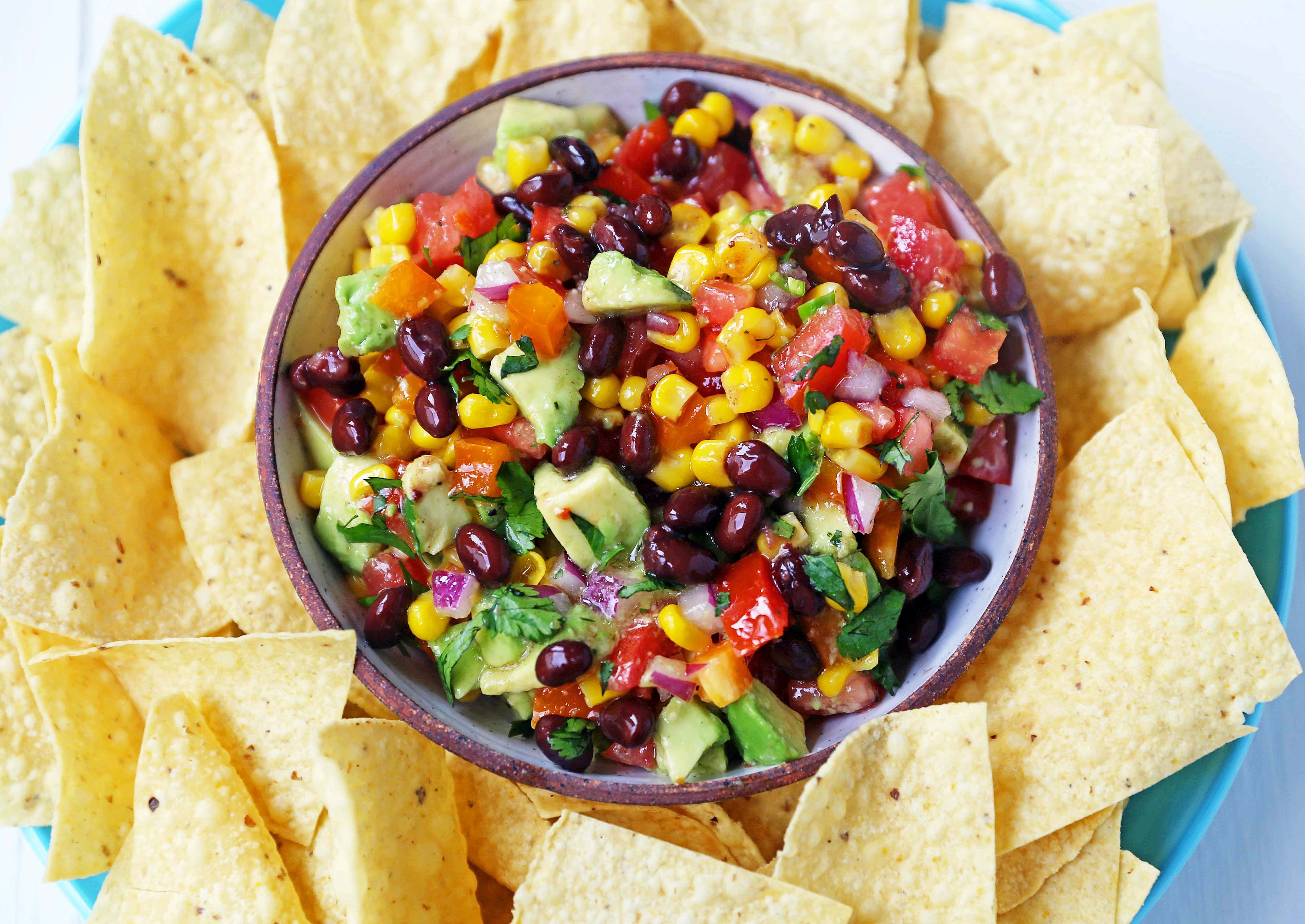 Cowboy Caviar. A popular, crowd-pleasing appetizer made with black beans, corn, tomatoes, cilantro, avocado, peppers, all tossed in a zesty dressing. www.modernhoney.com #cowboycaviar #appetizer #salsa #cornsalsa #blackbeansalsa #appetizers