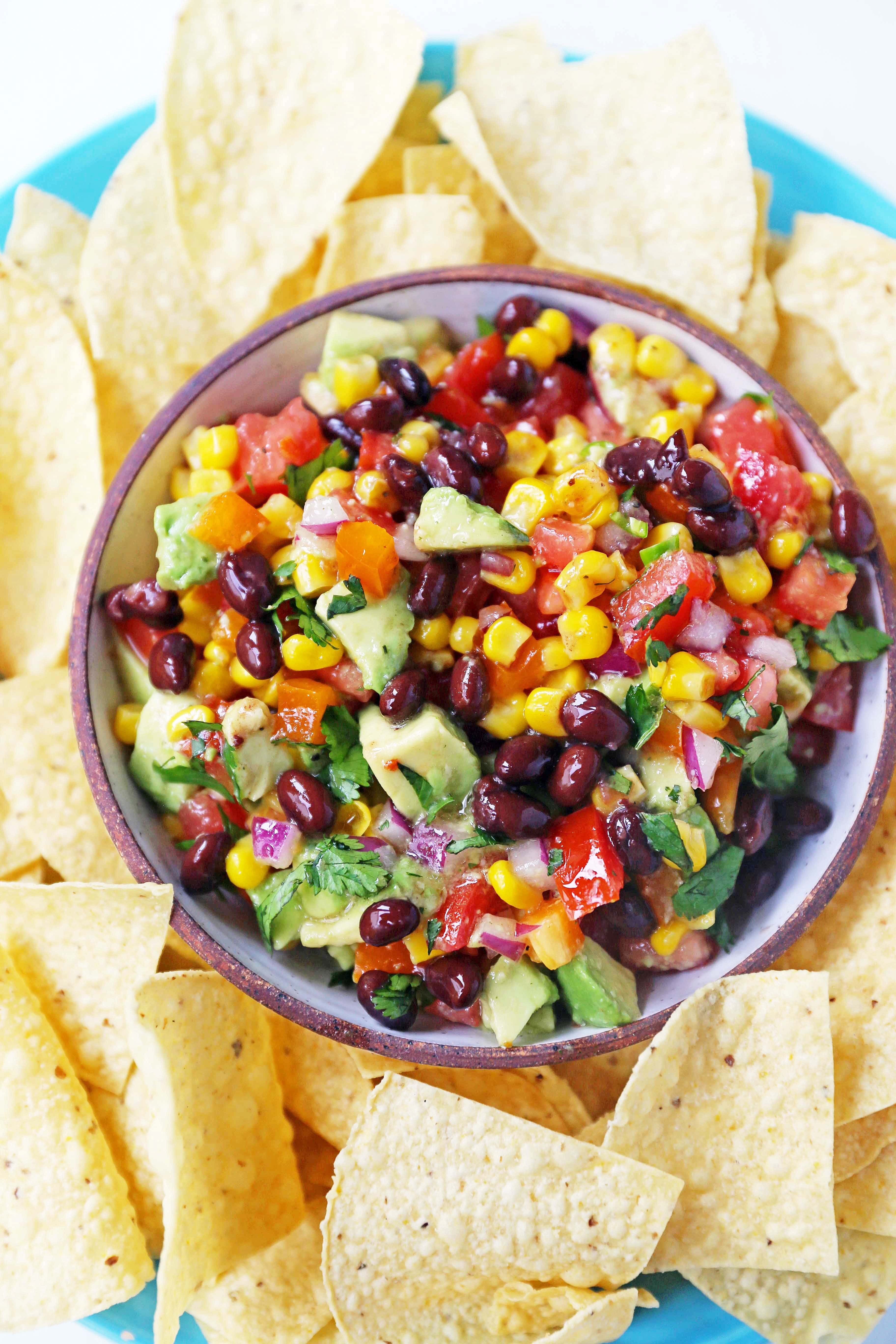 Cowboy Caviar. A popular, crowd-pleasing appetizer made with black beans, corn, tomatoes, cilantro, avocado, peppers, all tossed in a zesty dressing. www.modernhoney.com #cowboycaviar #appetizer #salsa #cornsalsa #blackbeansalsa #appetizers