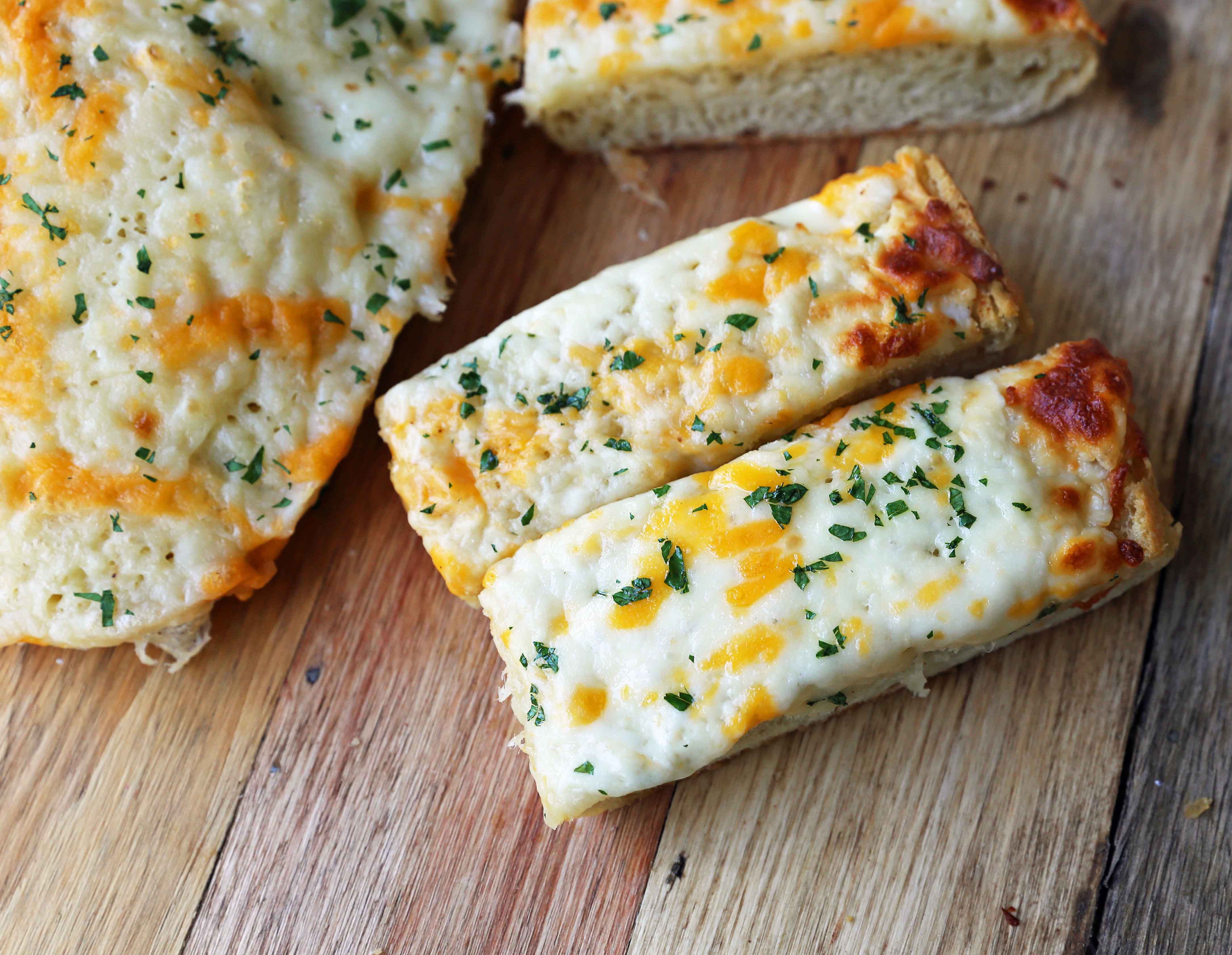 Quick and Easy Garlic Cheese Bread. Warm bread toasted and slathered with garlic butter and melted ooey gooey cheese. Garlic Cheese Bread is the perfect side dish or appetizer. www.modernhoney.com #appetizer #sidedish #garlicbread #garliccheesebread #cheesebread