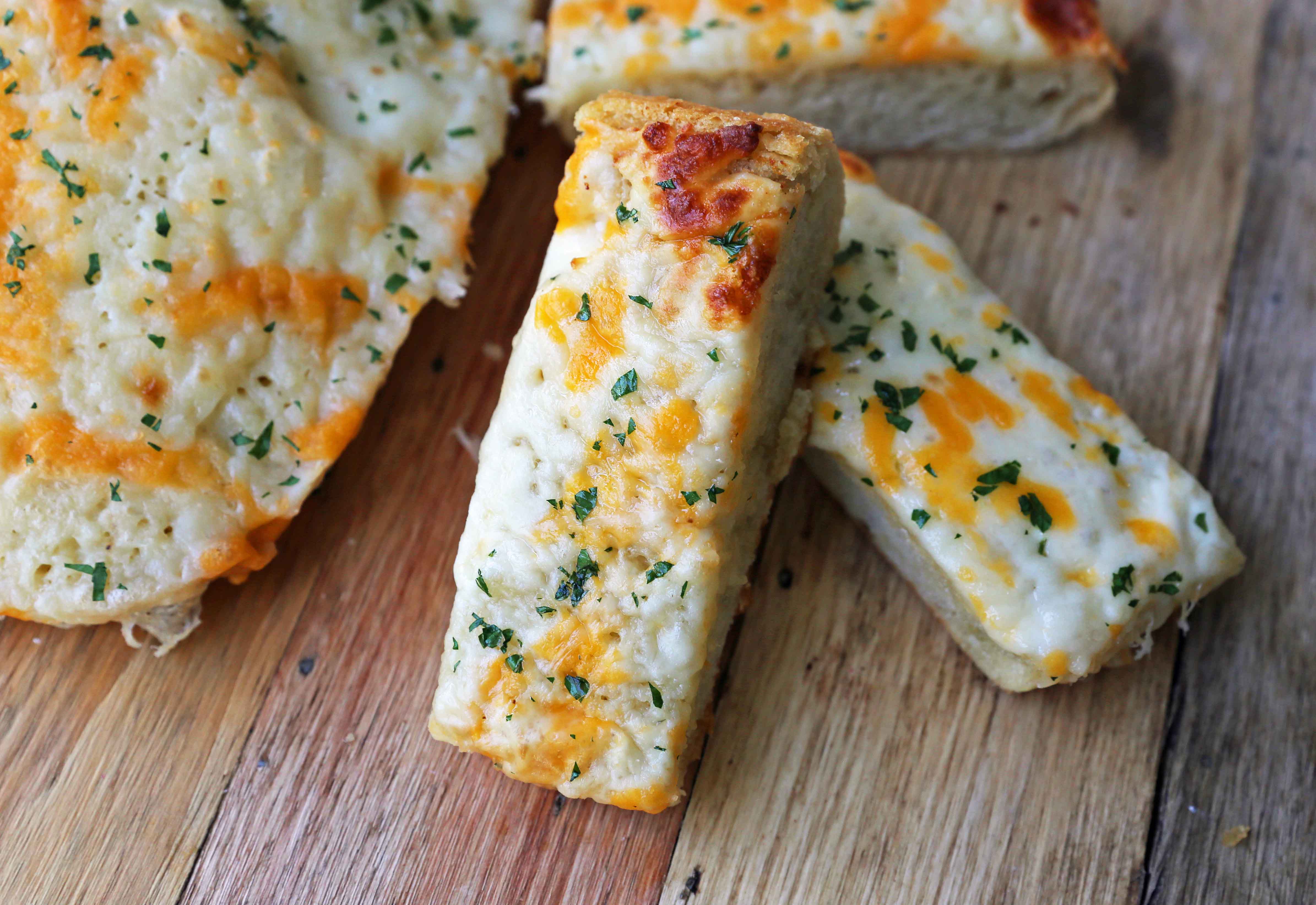 Quick and Easy Garlic Cheese Bread. Warm bread toasted and slathered with garlic butter and melted ooey gooey cheese. Garlic Cheese Bread is the perfect side dish or appetizer. www.modernhoney.com #appetizer #sidedish #garlicbread #garliccheesebread #cheesebread