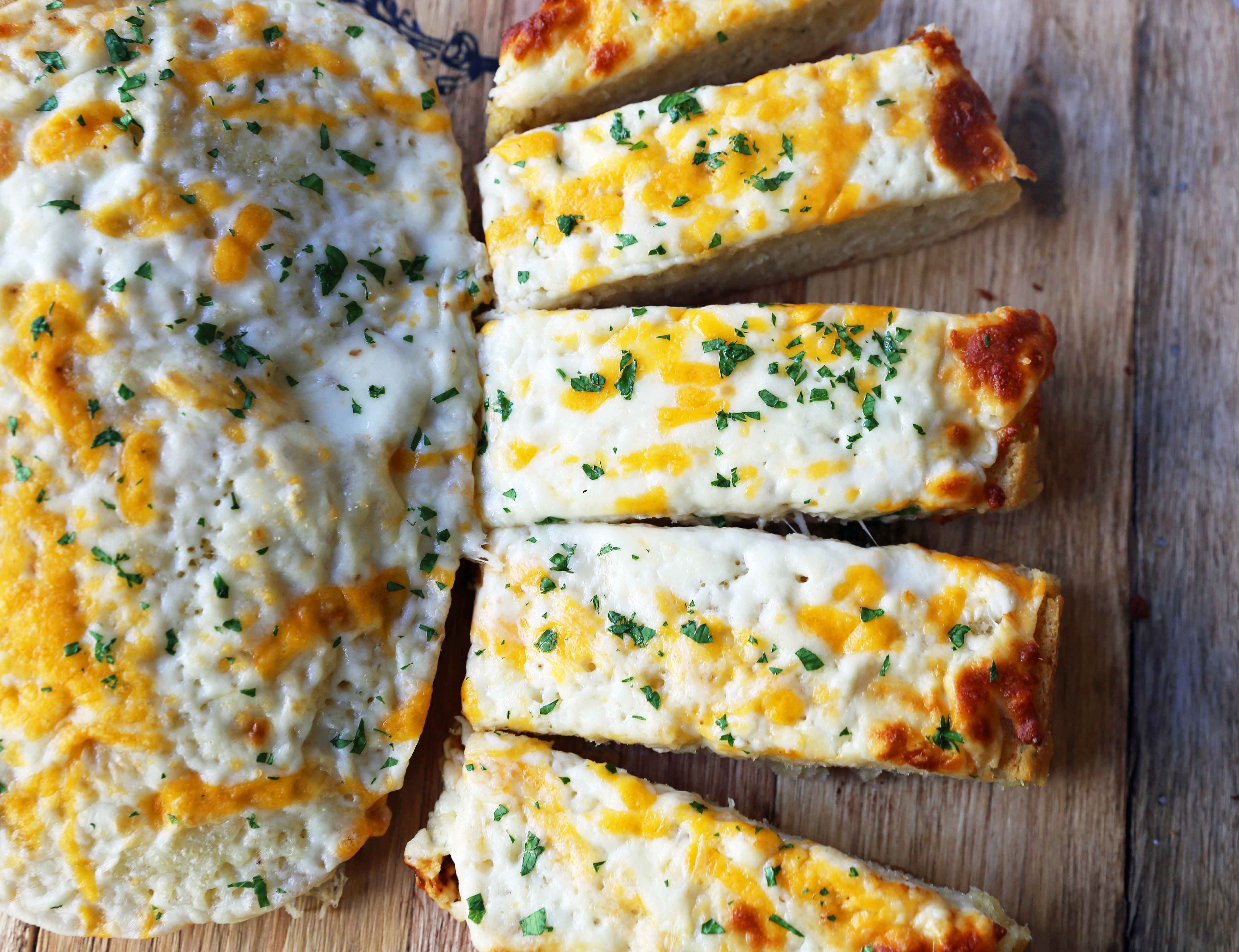 Quick and Easy Garlic Cheese Bread. Warm bread toasted and slathered with garlic butter and melted ooey gooey cheese. Garlic Cheese Bread is the perfect side dish or appetizer. www.modernhoney.com #appetizer #sidedish #garlicbread #garliccheesebread #cheesebread