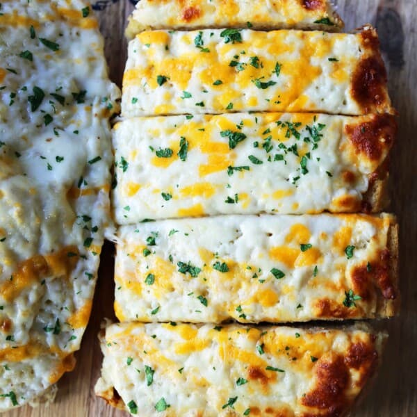 Quick and Easy Garlic Cheese Bread. Warm bread toasted and slathered with garlic butter and melted ooey gooey cheese. Garlic Cheese Bread is the perfect side dish or appetizer. www.modernhoney.com #appetizer #sidedish #garlicbread #garliccheesebread #cheesebread