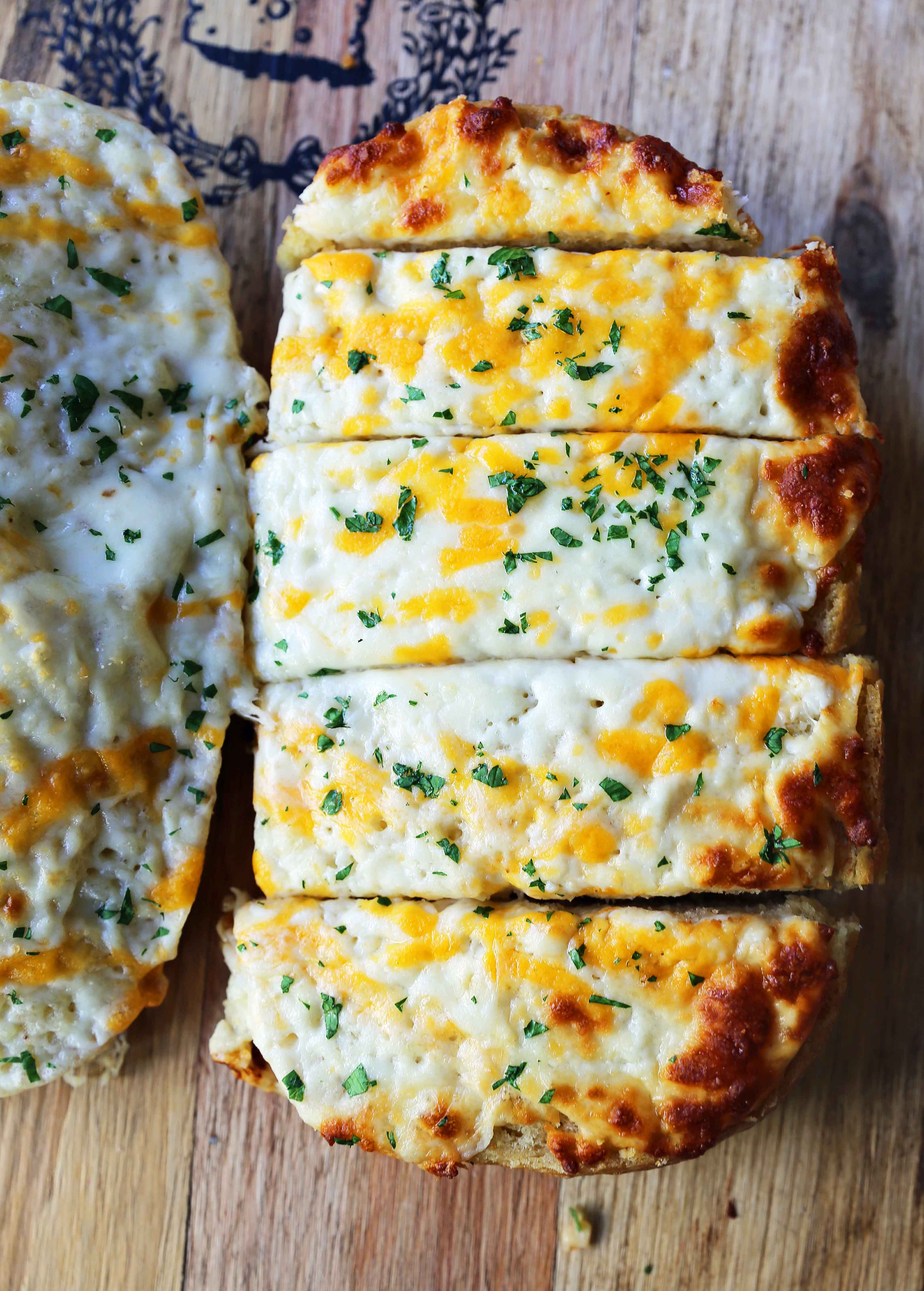 Quick and Easy Garlic Cheese Bread. Warm bread toasted and slathered with garlic butter and melted ooey gooey cheese. Garlic Cheese Bread is the perfect side dish or appetizer. www.modernhoney.com #appetizer #sidedish #garlicbread #garliccheesebread #cheesebread