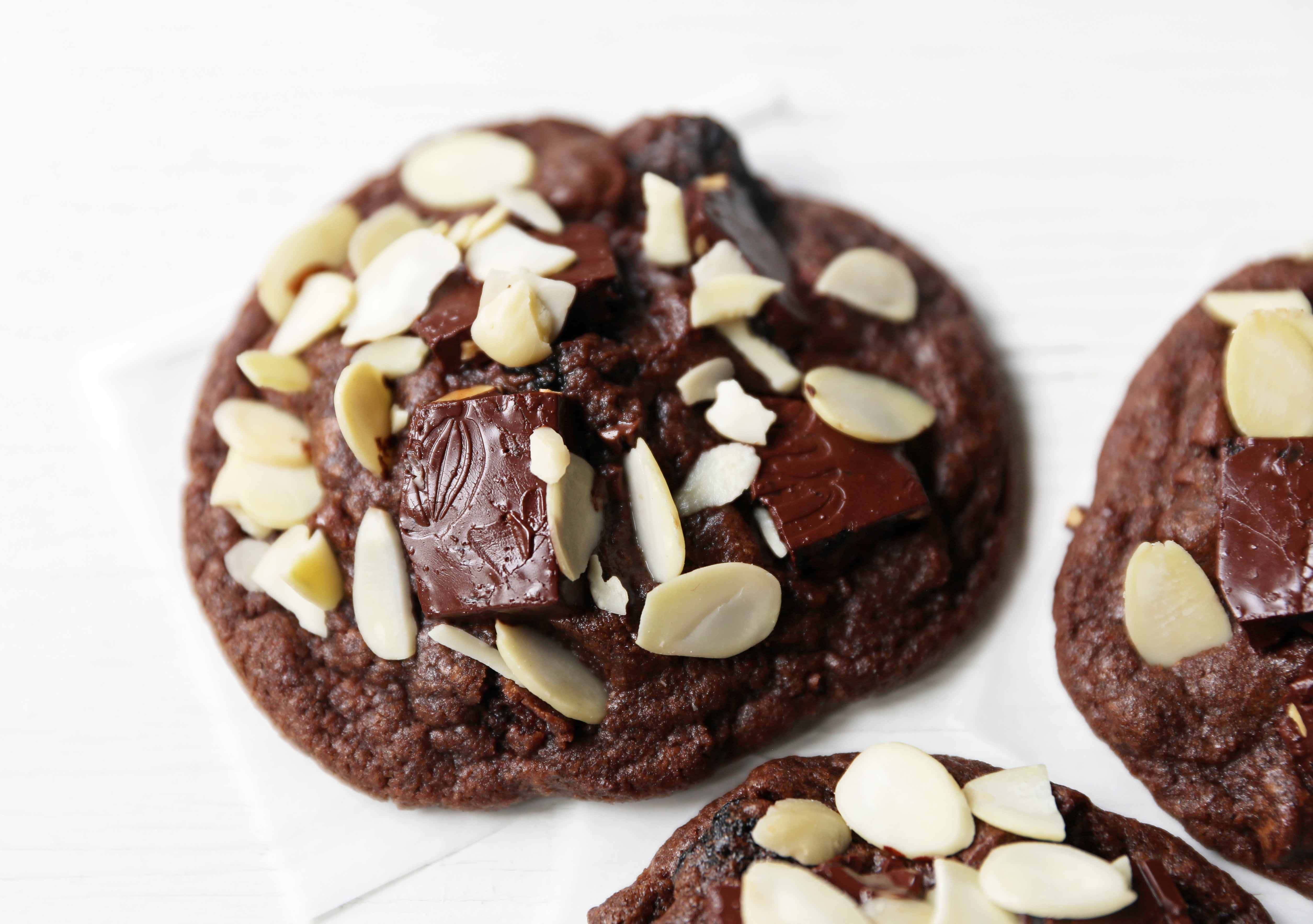 Chocolate Cherry Almond Cookies. Decadent chocolate chunk cookies with dried cherries and sliced almonds. A rich chocolate cherry chunk cookie! www.modernhoney.com #cherrychocolatecookies #chocolatecherrycookies #chocolatecookies #chocolatecookie 