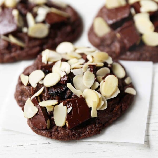 Chocolate Cherry Almond Cookies. Decadent chocolate chunk cookies with dried cherries and sliced almonds. A rich chocolate cherry chunk cookie! www.modernhoney.com #cherrychocolatecookies #chocolatecherrycookies #chocolatecookies #chocolatecookie