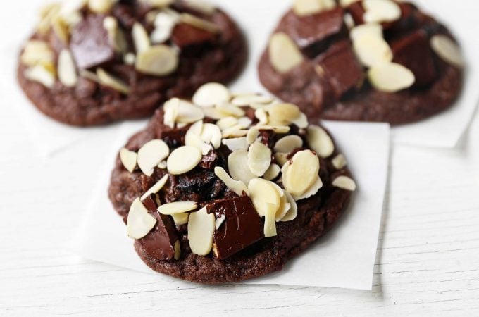 Chocolate Cherry Almond Cookies. Decadent chocolate chunk cookies with dried cherries and sliced almonds. A rich chocolate cherry chunk cookie! www.modernhoney.com #cherrychocolatecookies #chocolatecherrycookies #chocolatecookies #chocolatecookie