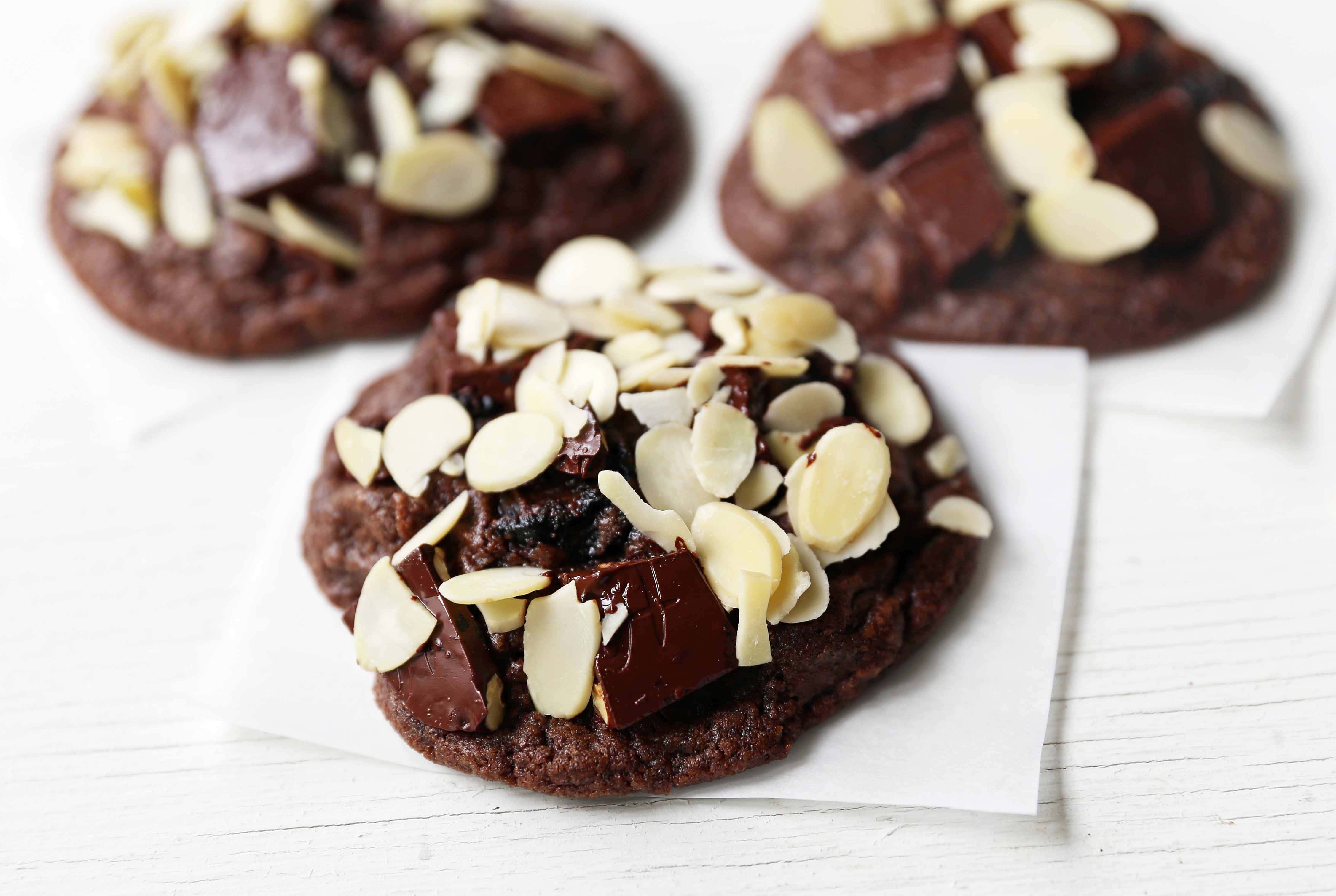 Chocolate Cherry Almond Cookies. Decadent chocolate chunk cookies with dried cherries and sliced almonds. A rich chocolate cherry chunk cookie! www.modernhoney.com #cherrychocolatecookies #chocolatecherrycookies #chocolatecookies #chocolatecookie 