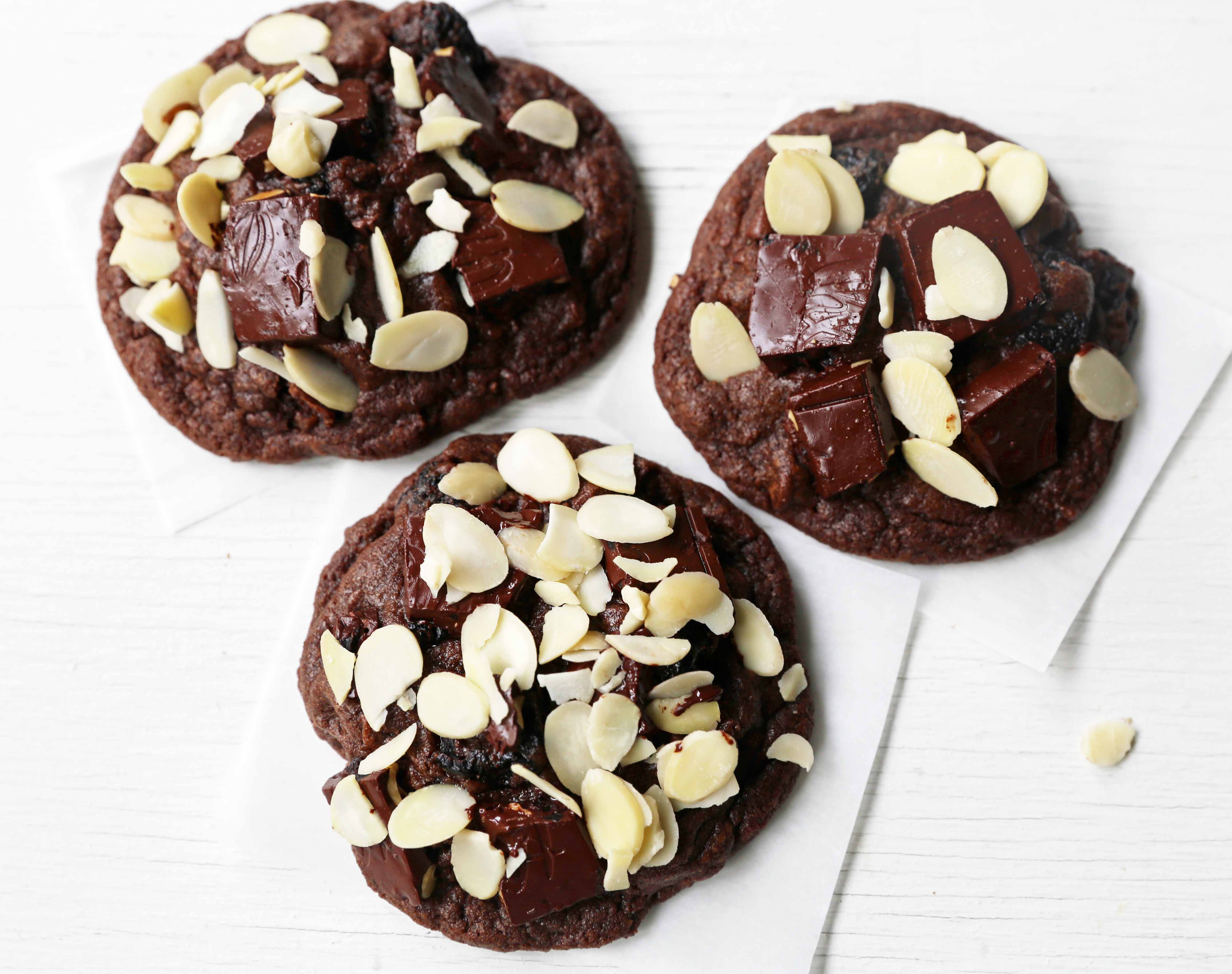 Chocolate Cherry Almond Cookies. Decadent chocolate chunk cookies with dried cherries and sliced almonds. A rich chocolate cherry chunk cookie! www.modernhoney.com #cherrychocolatecookies #chocolatecherrycookies #chocolatecookies #chocolatecookie 