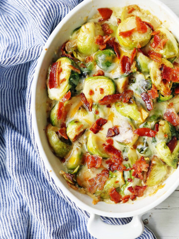 Creamy Cheesy Brussels Sprouts with Bacon. Roasted brussels sprouts with crispy bacon, a creamy sauce, and melted cheese. www.modernhoney.com #brusselsprouts #brusselsprouts #sidedish #vegetables