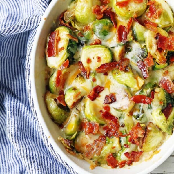 Creamy Cheesy Brussels Sprouts with Bacon. Roasted brussels sprouts with crispy bacon, a creamy sauce, and melted cheese. www.modernhoney.com #brusselsprouts #brusselsprouts #sidedish #vegetables