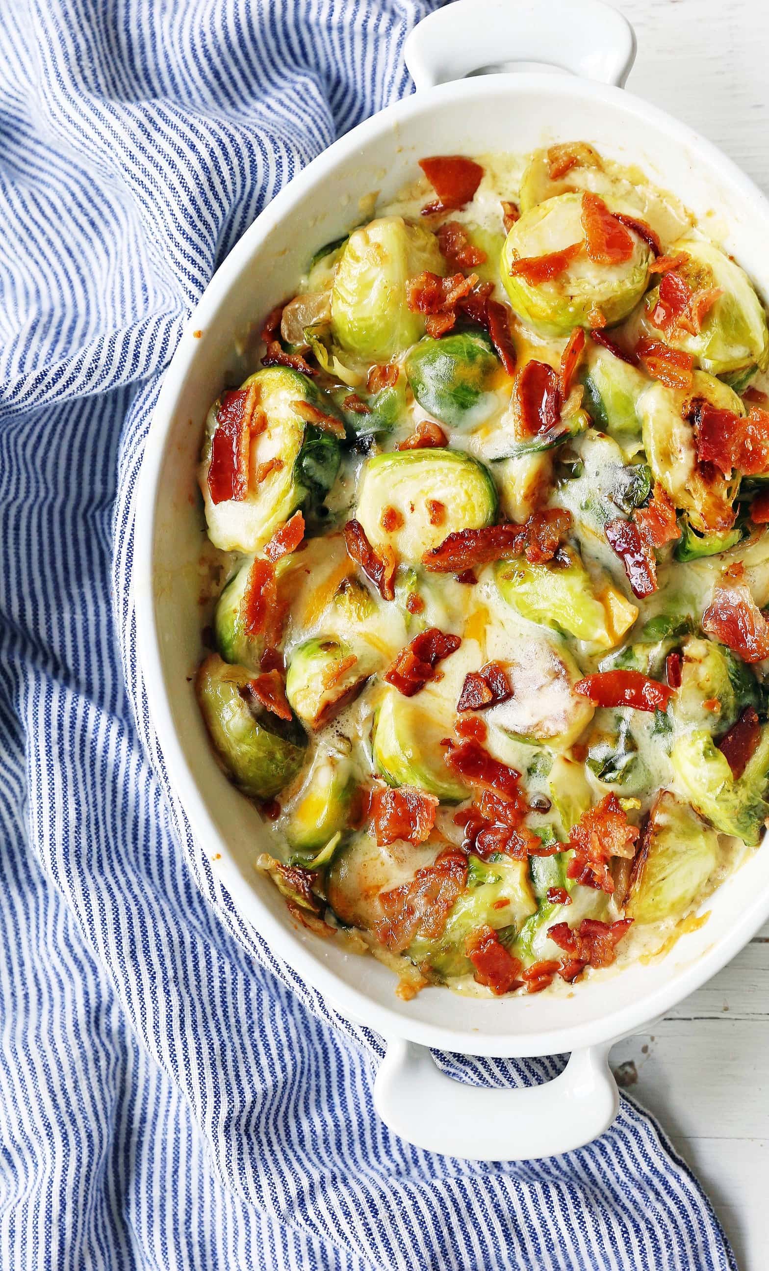 Creamy Cheesy Brussels Sprouts with Bacon. Roasted brussels sprouts with crispy bacon, a creamy sauce, and melted cheese. www.modernhoney.com #brusselsprouts #brusselsprouts #sidedish #vegetables 