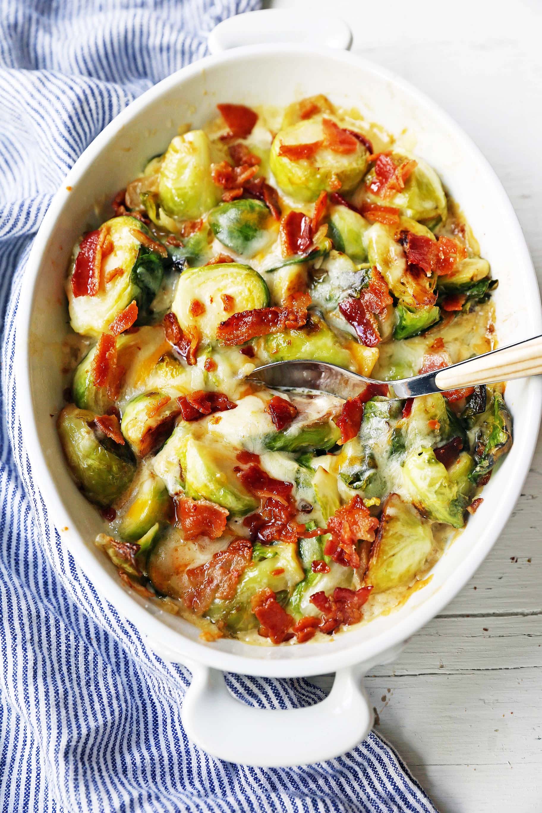 Creamy Cheesy Brussels Sprouts with Bacon. Roasted brussels sprouts with crispy bacon, a creamy sauce, and melted cheese. www.modernhoney.com #brusselsprouts #brusselsprouts #sidedish #vegetables 