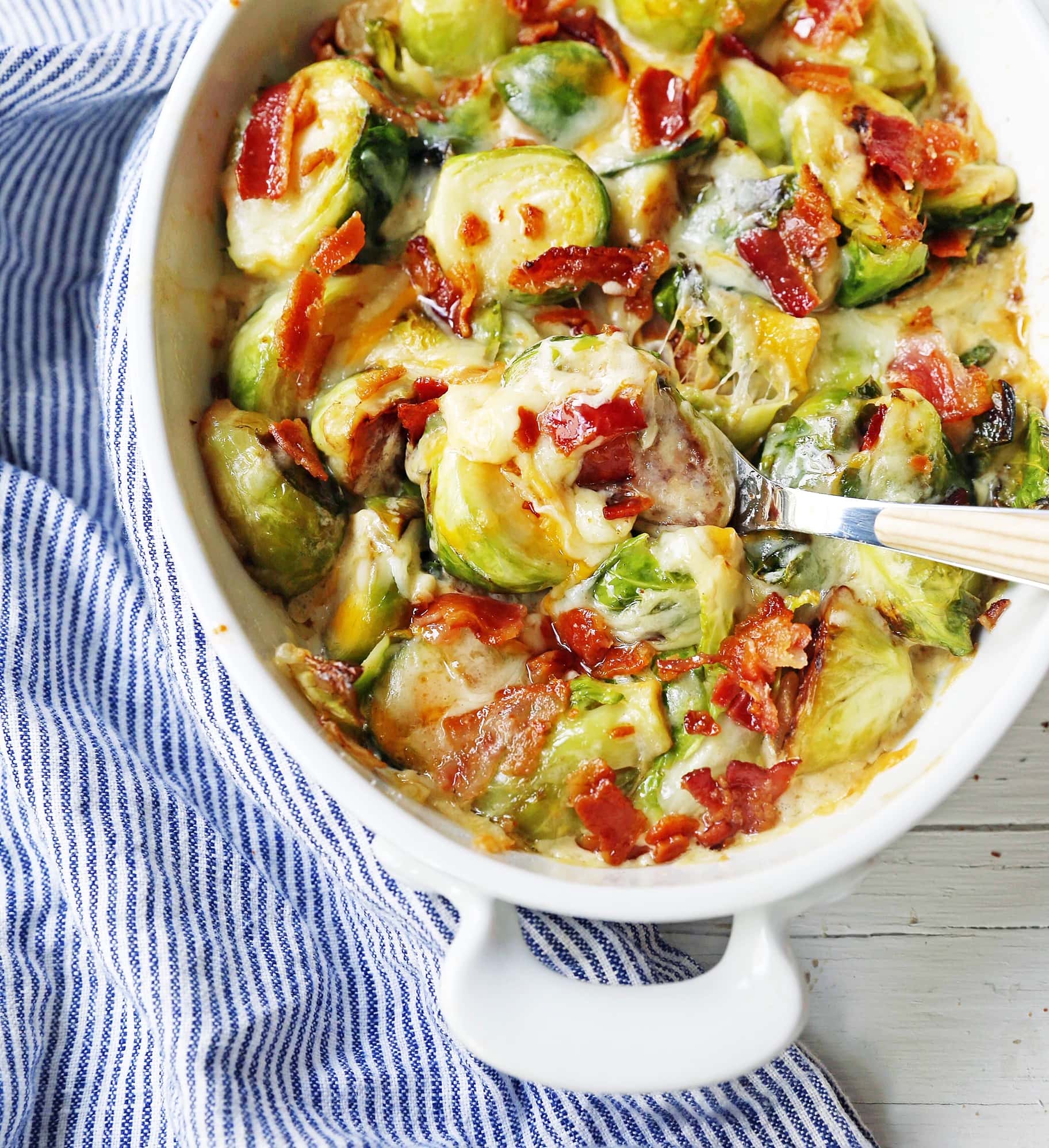 Creamy Cheesy Brussels Sprouts with Bacon. Roasted brussels sprouts with crispy bacon, a creamy sauce, and melted cheese. www.modernhoney.com #brusselsprouts #brusselsprouts #sidedish #vegetables 