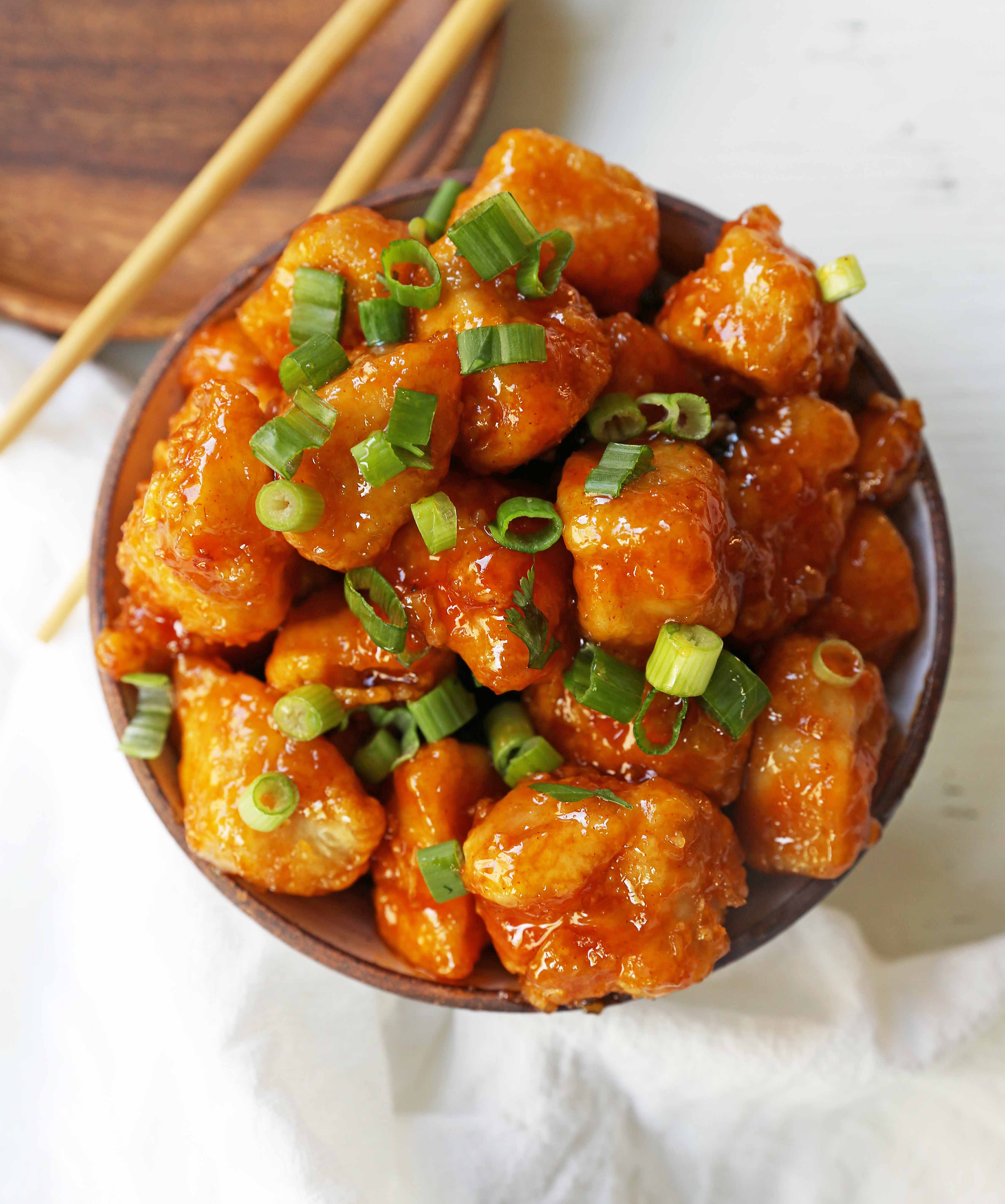 Firecracker Chicken. Sweet and spicy chicken bites made with tender chicken, flash-fried, and baked in a sweet brown sugar buffalo sauce. You'll have people coming back for seconds in no time at all! www.modernhoney.com #firecrackerchicken #buffalochicken #chicken #chickenbites 