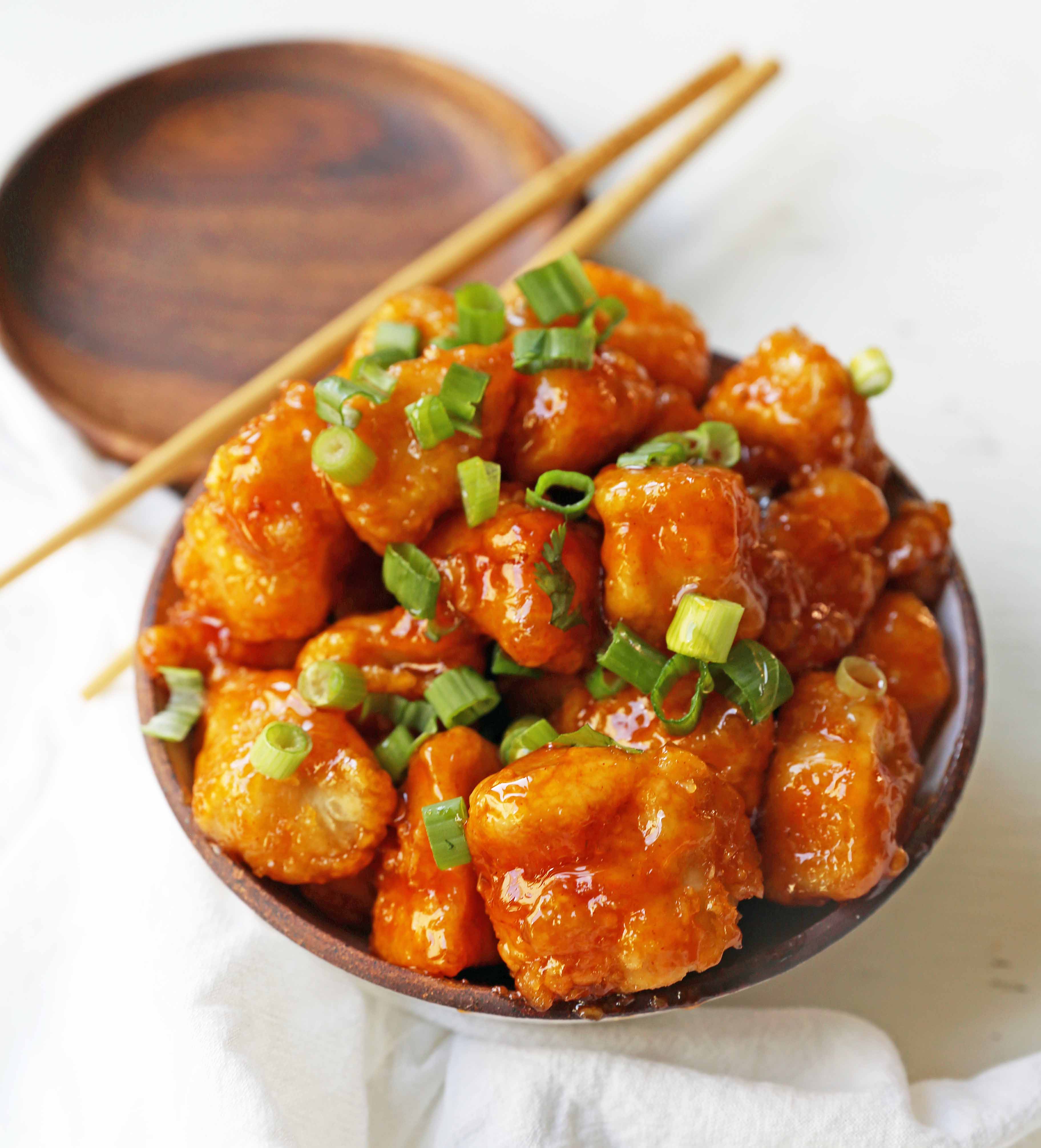Firecracker Chicken. Sweet and spicy chicken bites made with tender chicken, flash-fried, and baked in a sweet brown sugar buffalo sauce. You'll have people coming back for seconds in no time at all! www.modernhoney.com #firecrackerchicken #buffalochicken #chicken #chickenbites 