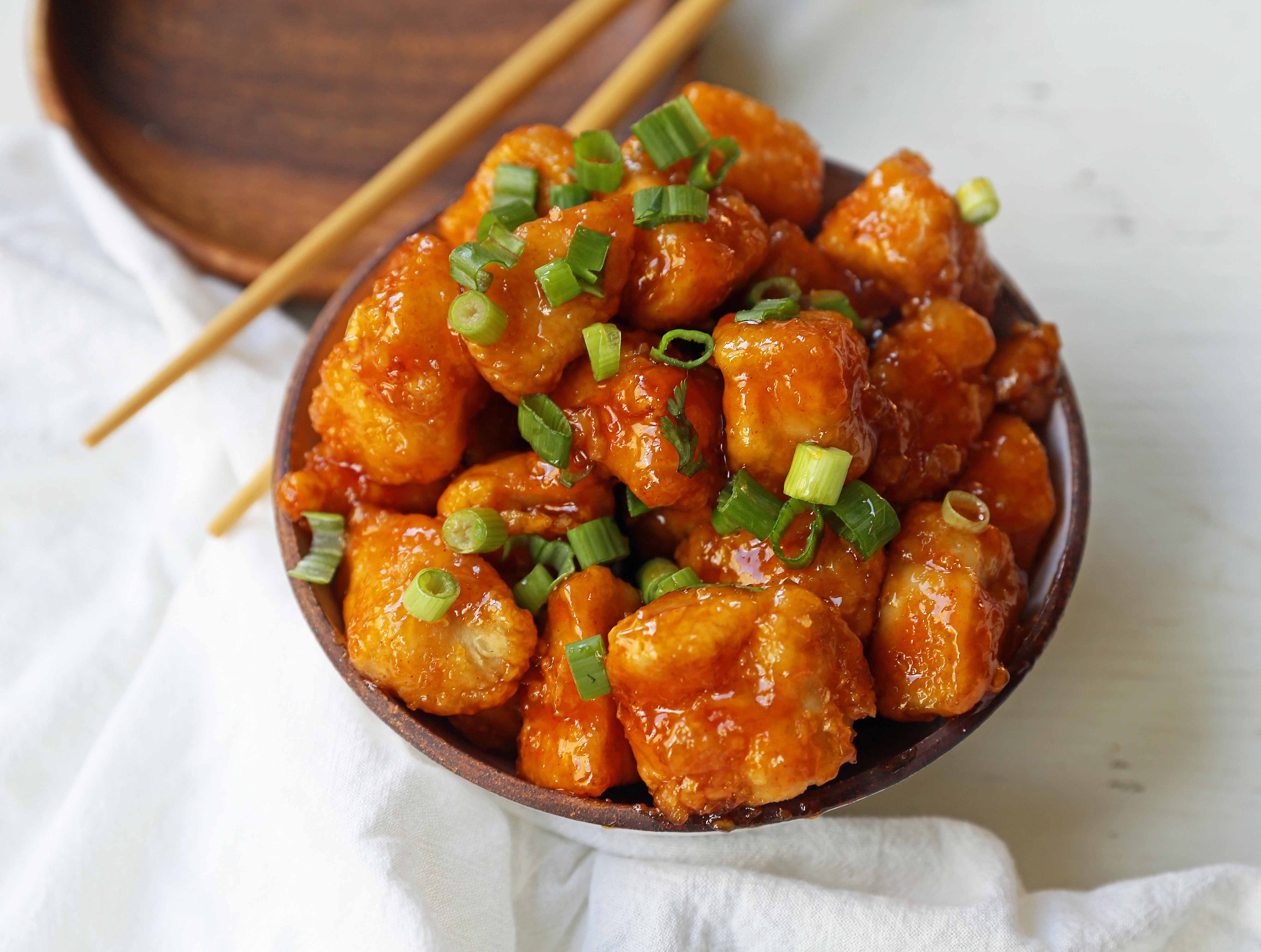 Firecracker Chicken. Sweet and spicy chicken bites made with tender chicken, flash-fried, and baked in a sweet brown sugar buffalo sauce. You'll have people coming back for seconds in no time at all! www.modernhoney.com #firecrackerchicken #buffalochicken #chicken #chickenbites 