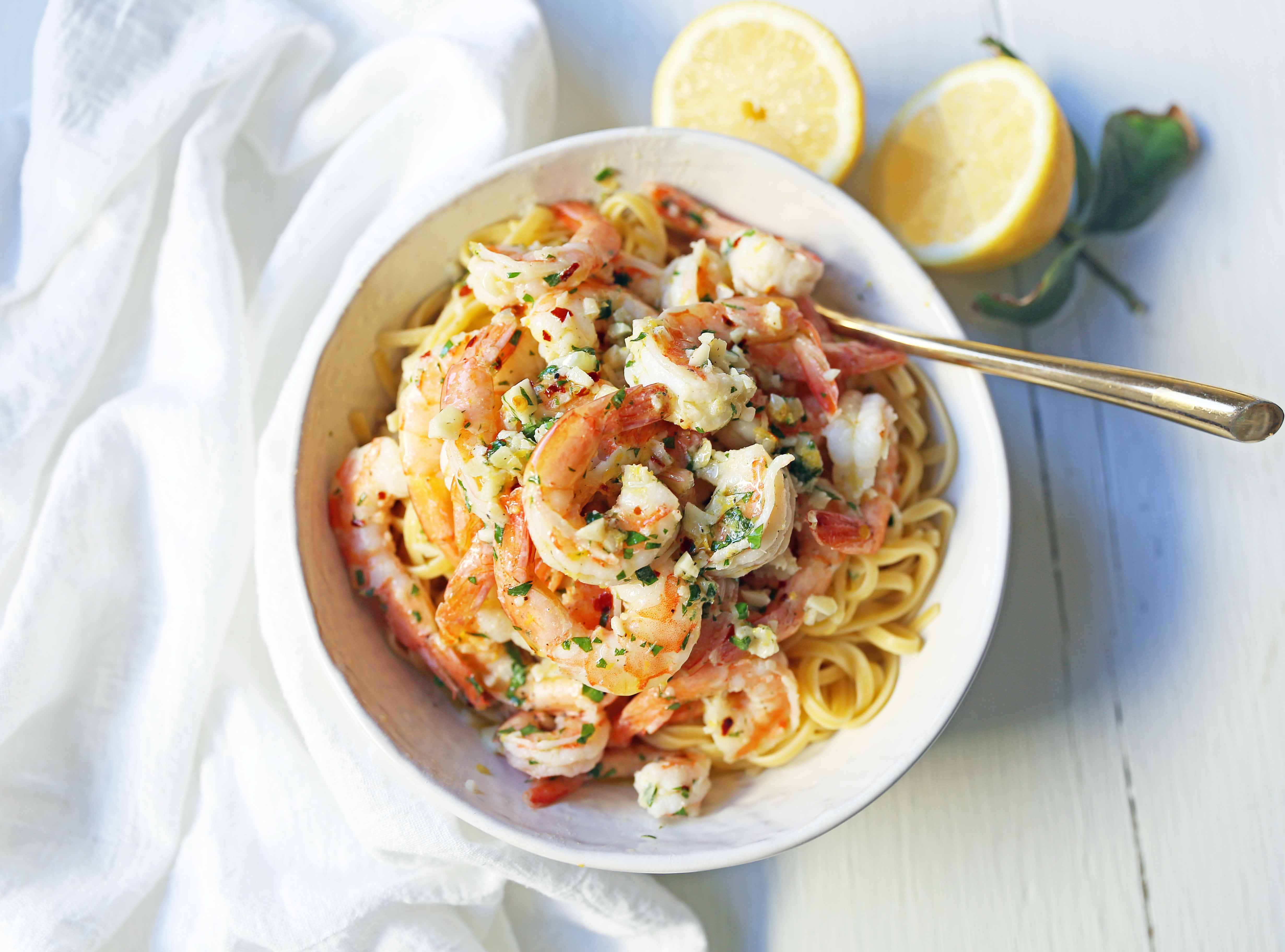 Shrimp Scampi Linguine. Shrimp sauteed in a lemon garlic butter sauce tossed with linguine pasta and made in less than 20 minutes. www.modernhoney.com #shrimp #shrimpscampi #shrimpscampilinguine #pasta #valentinesday