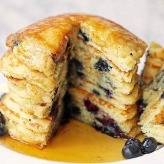 Homemade Blueberry Buttermilk Pancakes are light and fluffy. How to make the perfect blueberry pancakes. Tips and tricks for making the best blueberry pancakes. www.modernhoney.com #blueberrypancakes #blueberrybuttermilkpancakes #pancakes #pancakerecipes