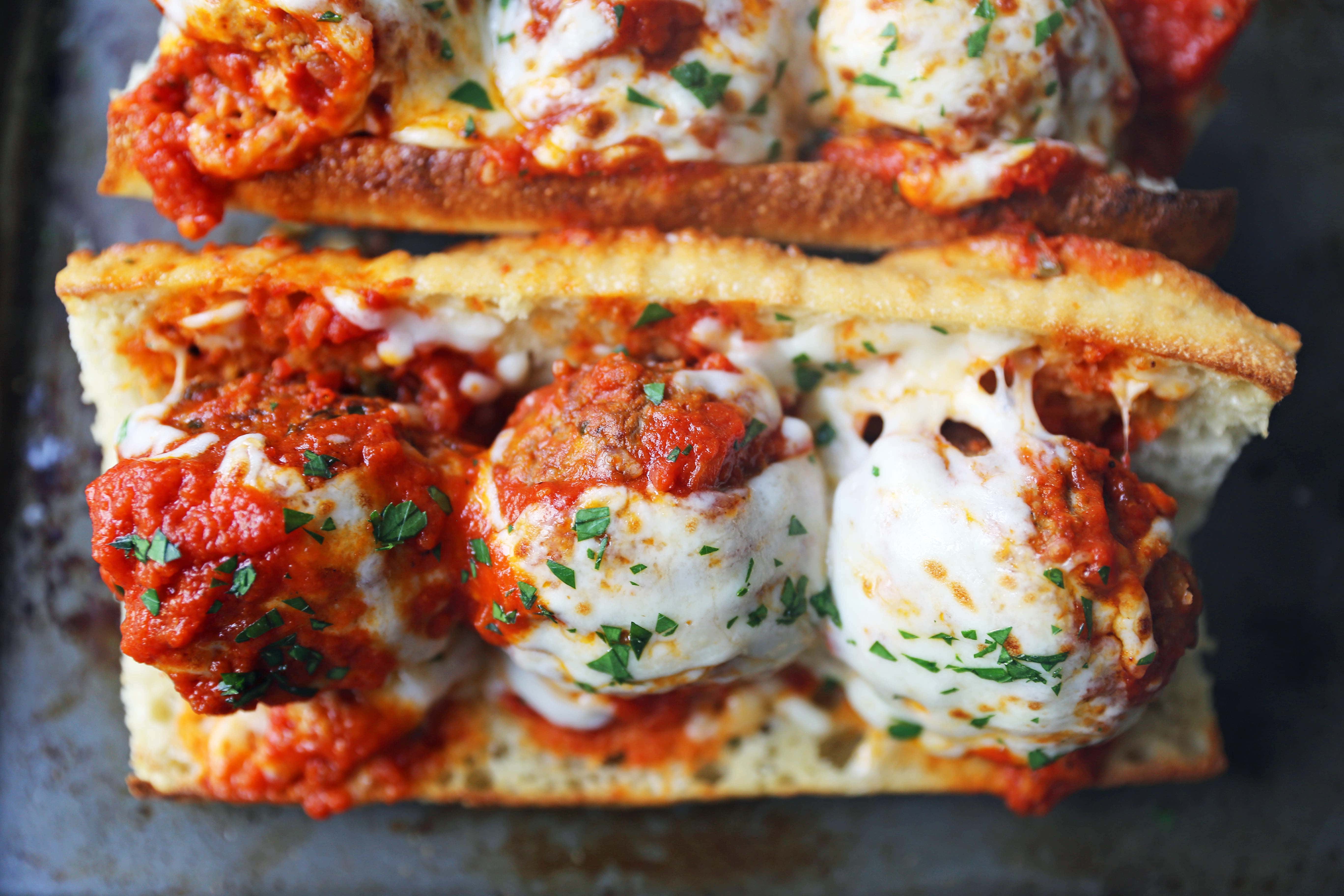 Italian Meatball Subs. Homemade beef parmesan meatballs in a fresh marinara sauce topped with melted mozzarella cheese all on toasted bread. The best meatball sub recipe! www.modernhoney.com #meatballs #meatball #meatballsub