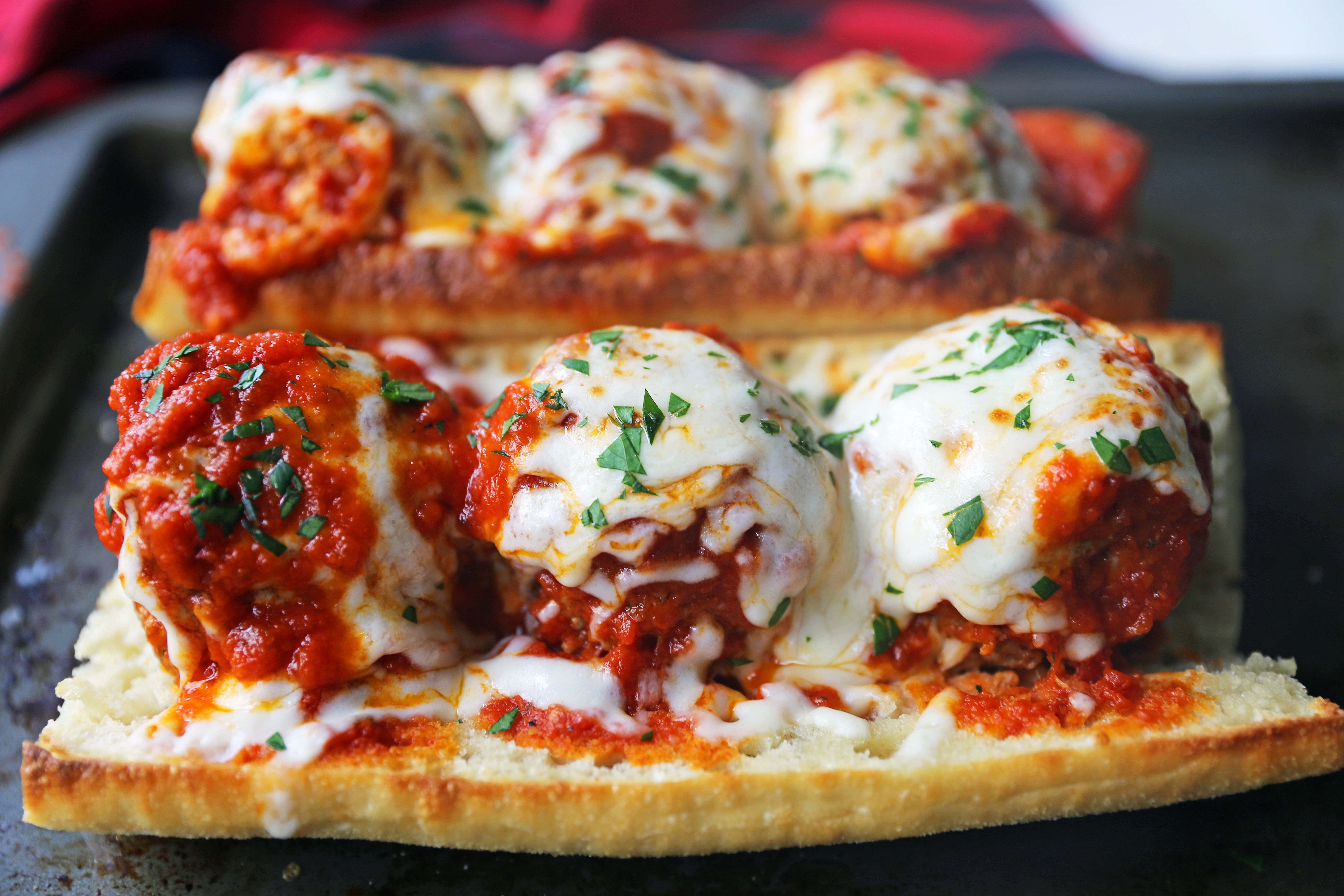 Italian Meatball Subs. Homemade beef parmesan meatballs in a fresh marinara sauce topped with melted mozzarella cheese all on toasted bread. The best meatball sub recipe! www.modernhoney.com #meatballs #meatball #meatballsub