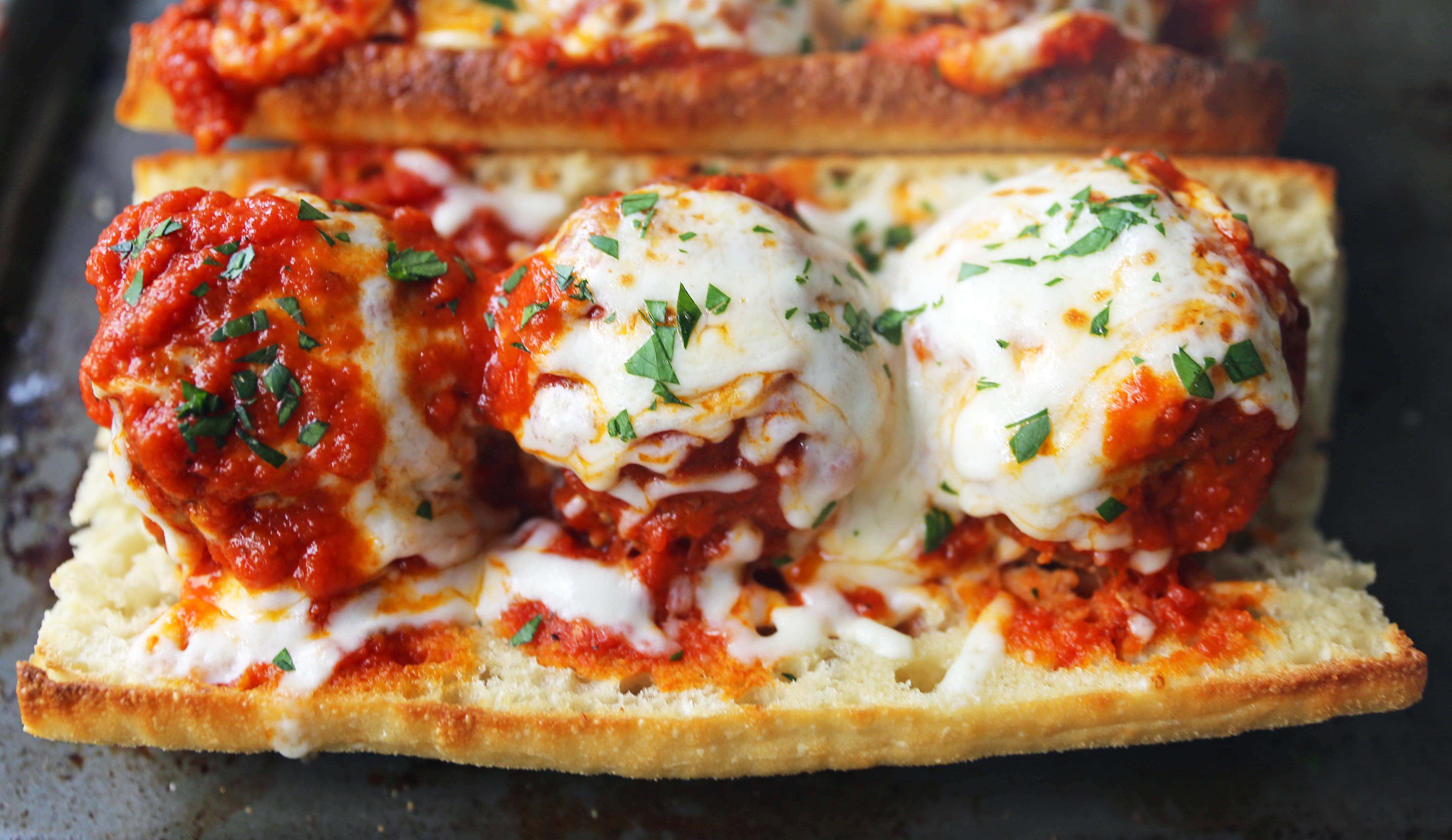 Italian Meatball Subs. Homemade beef parmesan meatballs in a fresh marinara sauce topped with melted mozzarella cheese all on toasted bread. The best meatball sub recipe! www.modernhoney.com #meatballs #meatball #meatballsub