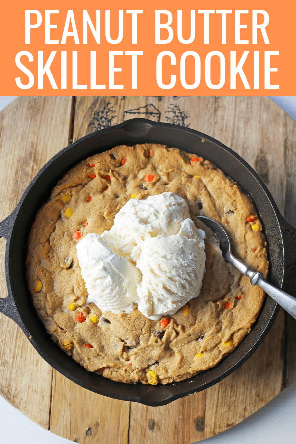 Peanut Butter Skillet Cookie. Homemade peanut butter cookie dough with Reeses Pieces baked until ooey gooey and topped with vanilla ice cream and hot fudge. www.modernhoney.com #peanutbutter #peanutbuttercookies #peanutbutterpizookie #pizookie