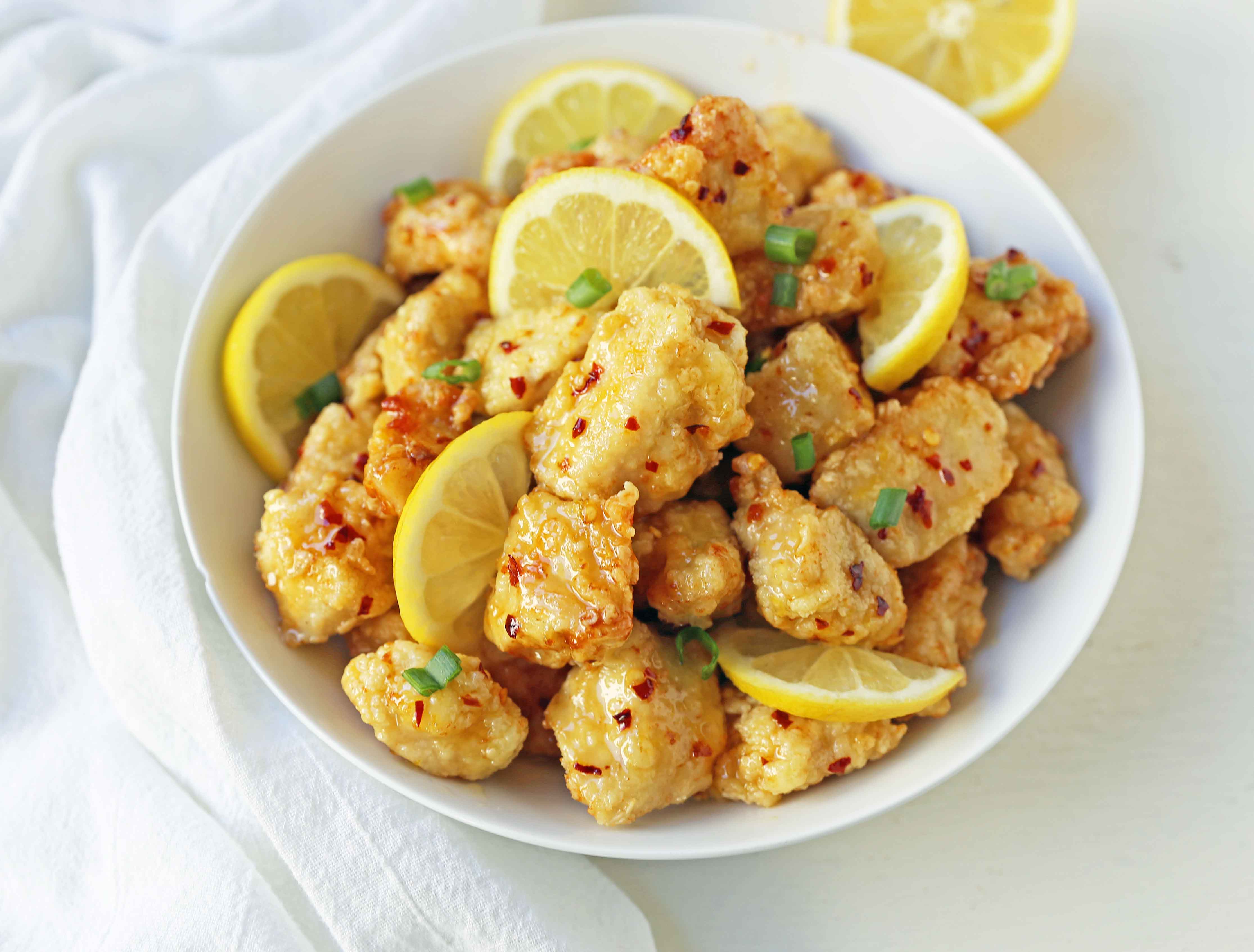 Chinese Lemon Chicken made with crispy fried chicken covered in an authentic, fresh lemon sauce. The ultimate Chinese Lemon Chicken Recipe which is way better than take-out. www.modernhoney.com #chinesefood #asianfood #lemonchicken #chineselemonchicken